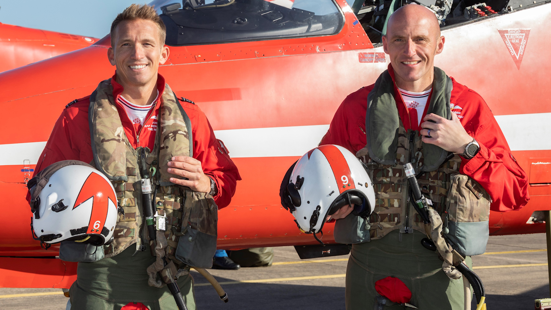Squadron Leaders Jon Bond, left, and Steve Morris after returning to RAF Scampton from their final Red Arrows display