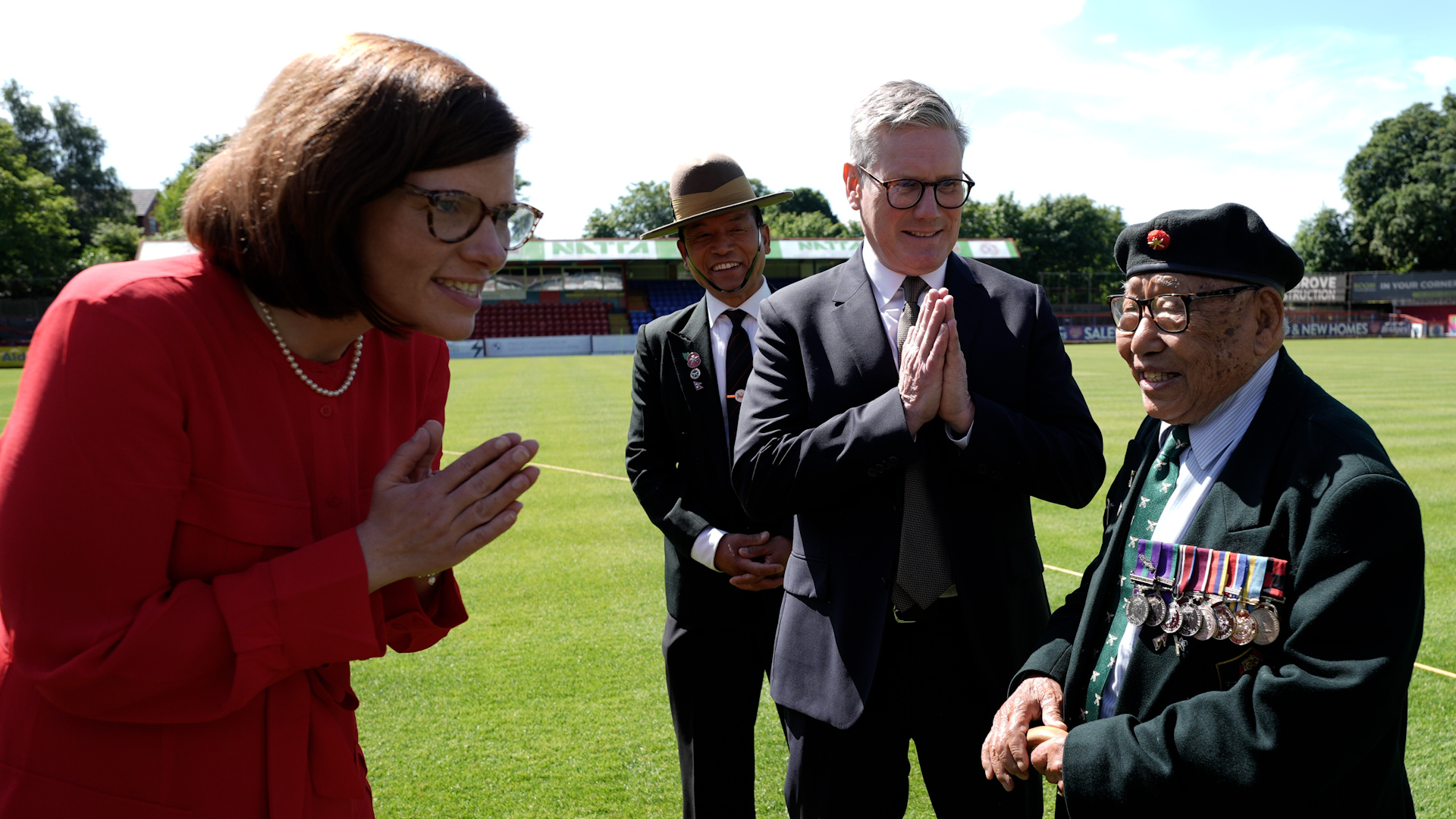 Aldershot's new MP Alex Baker and Sir Keir Starmer with a 93-year-old veteran at Aldershot Town FC