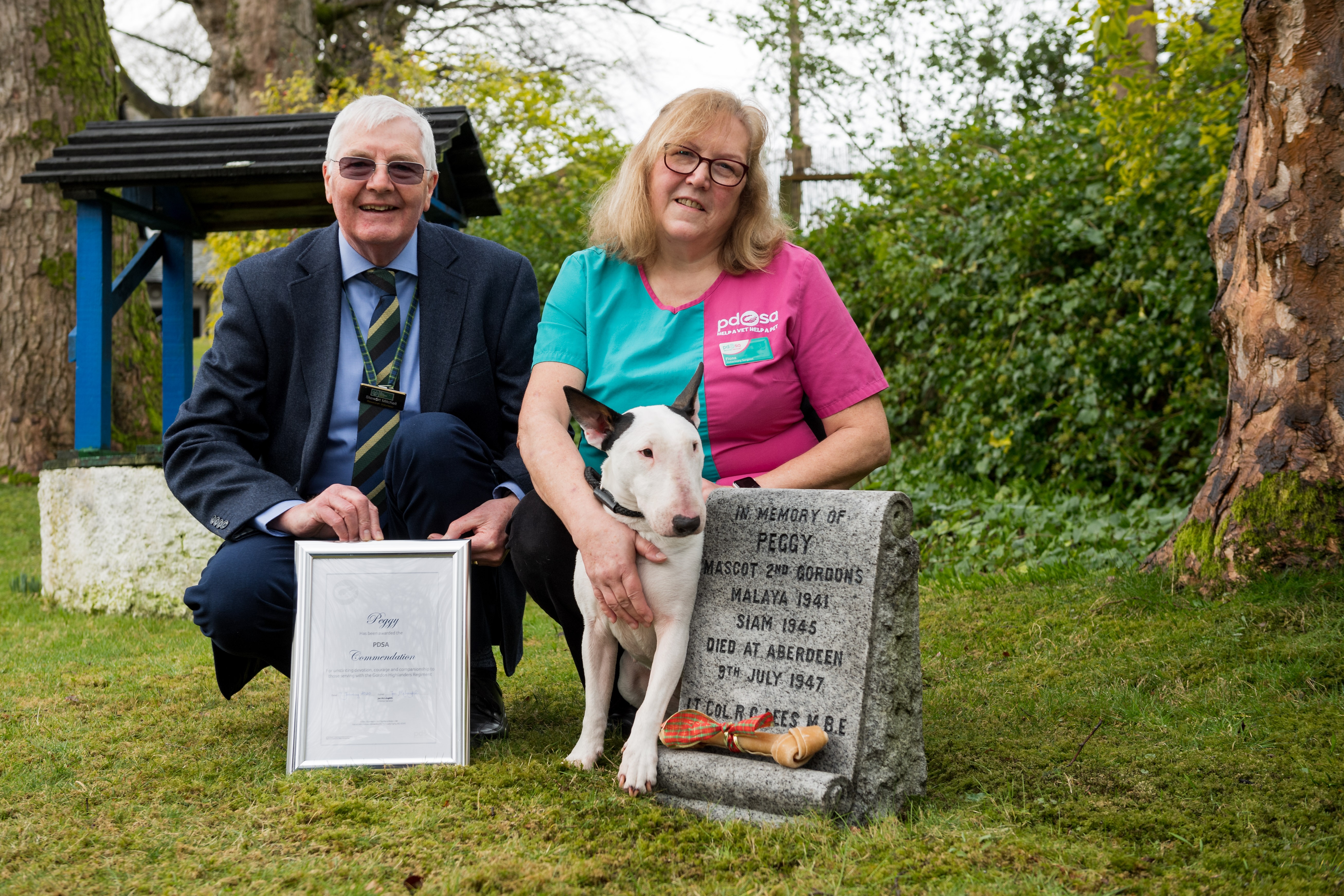 Volunteer historian Stewart Mitchell with vet Fiona Gregge, and Bull Terrier Billy at Peggy's grave (Picture: PDSA).