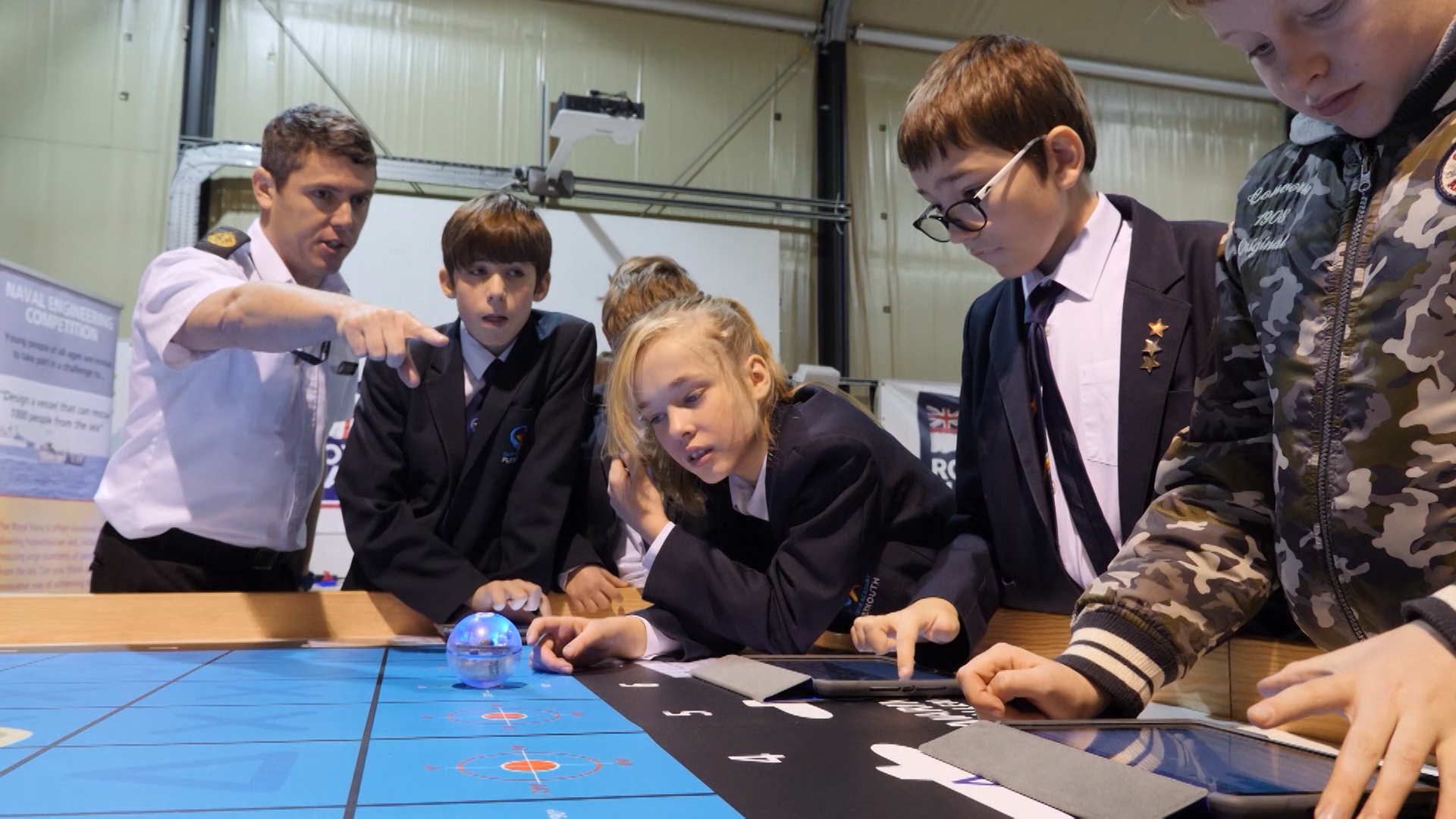 Students drive 'submarines' in the shape of spheres.