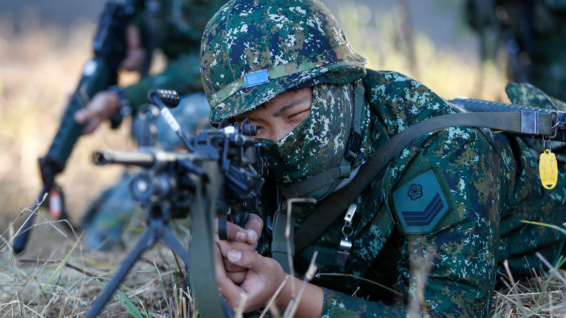 Taiwan has long-prepared for an amphibious invasion - this soldier deploys an LMG on one such drill - but Beijing is aware of this and an airborne insertion now seems more likely
