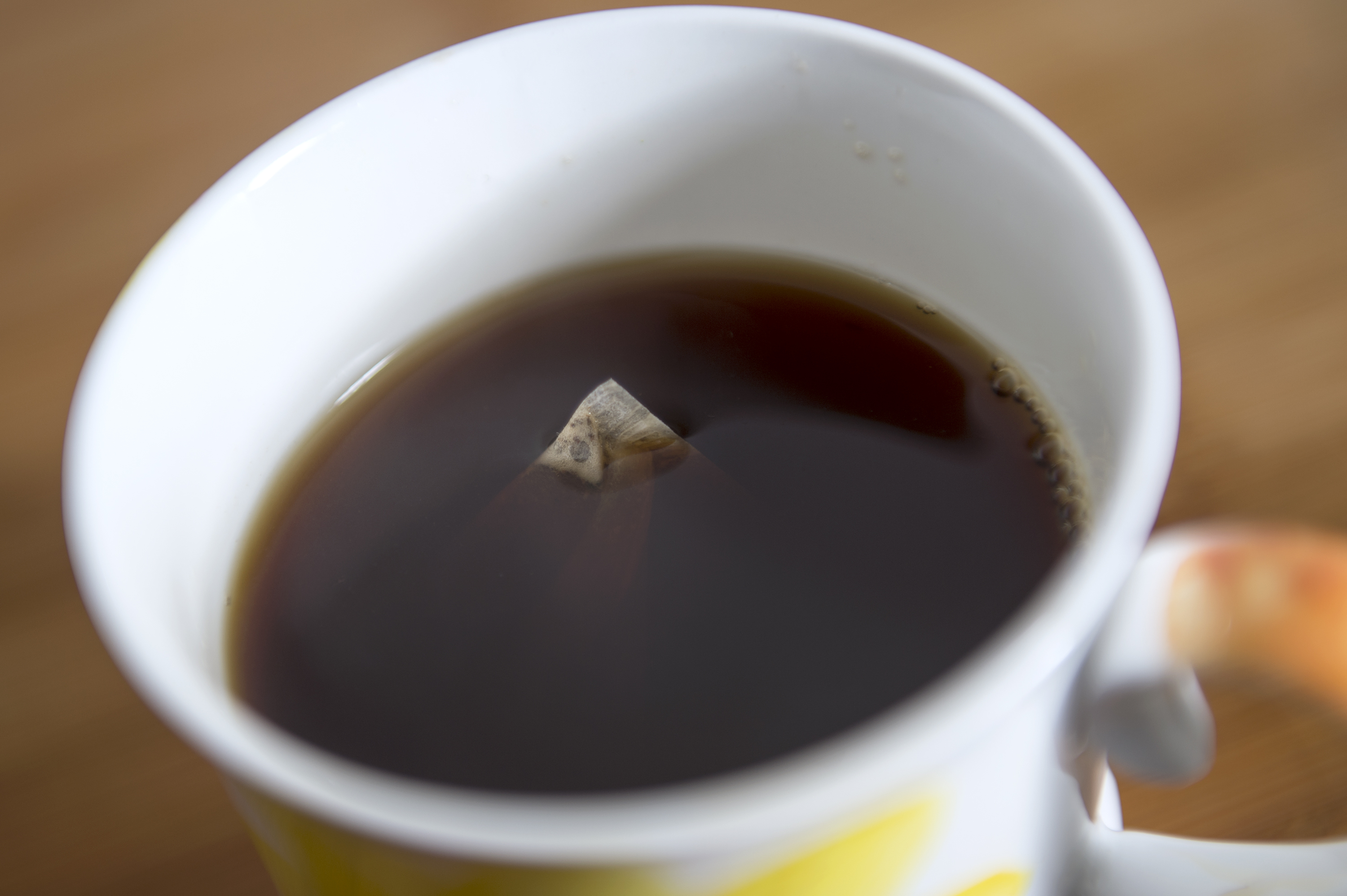 Tea bag floats in cup of tea
