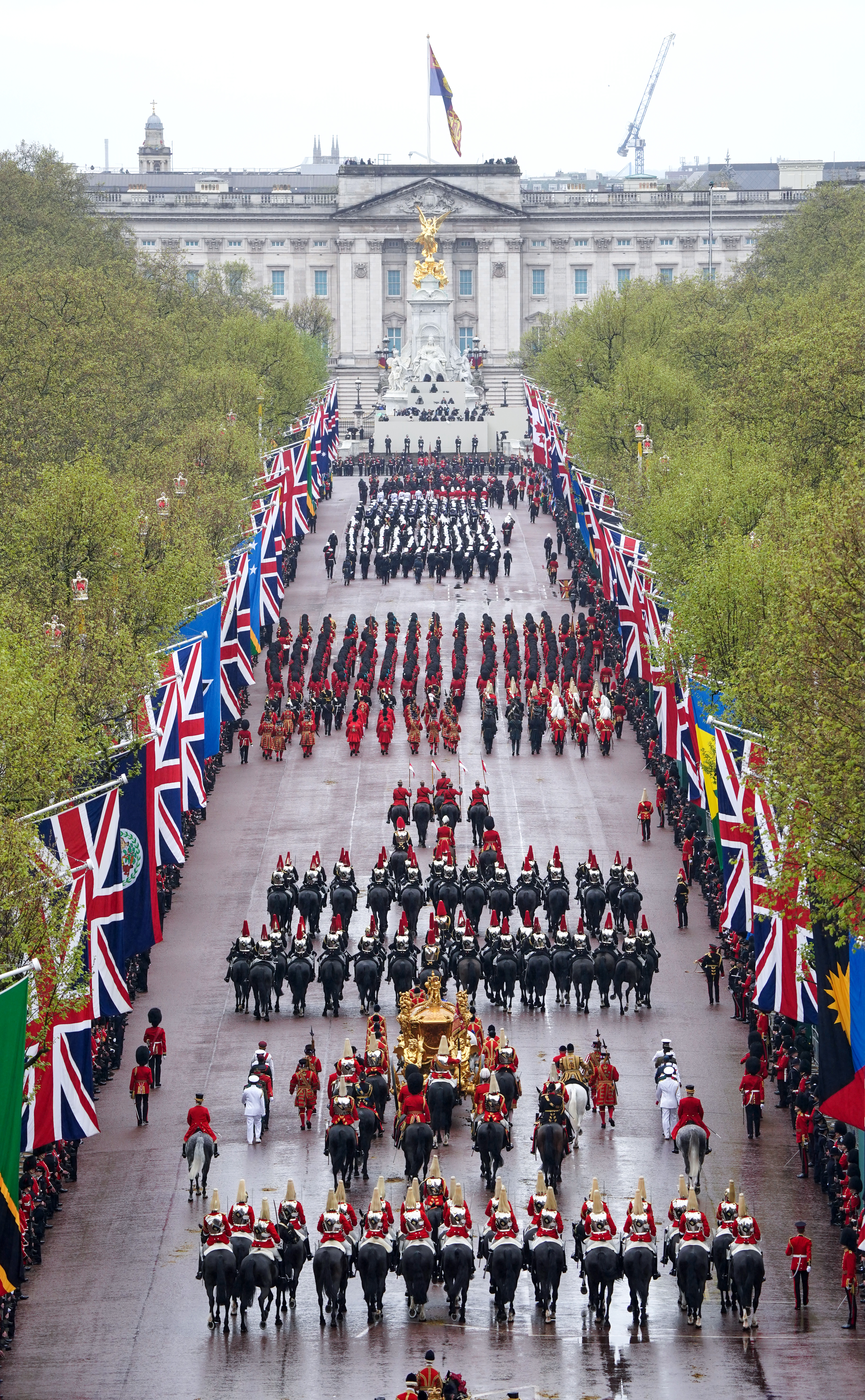 The Coronation Procession travels along The Mall following the coronation ceremony of King Charles III and Queen Camilla in central London