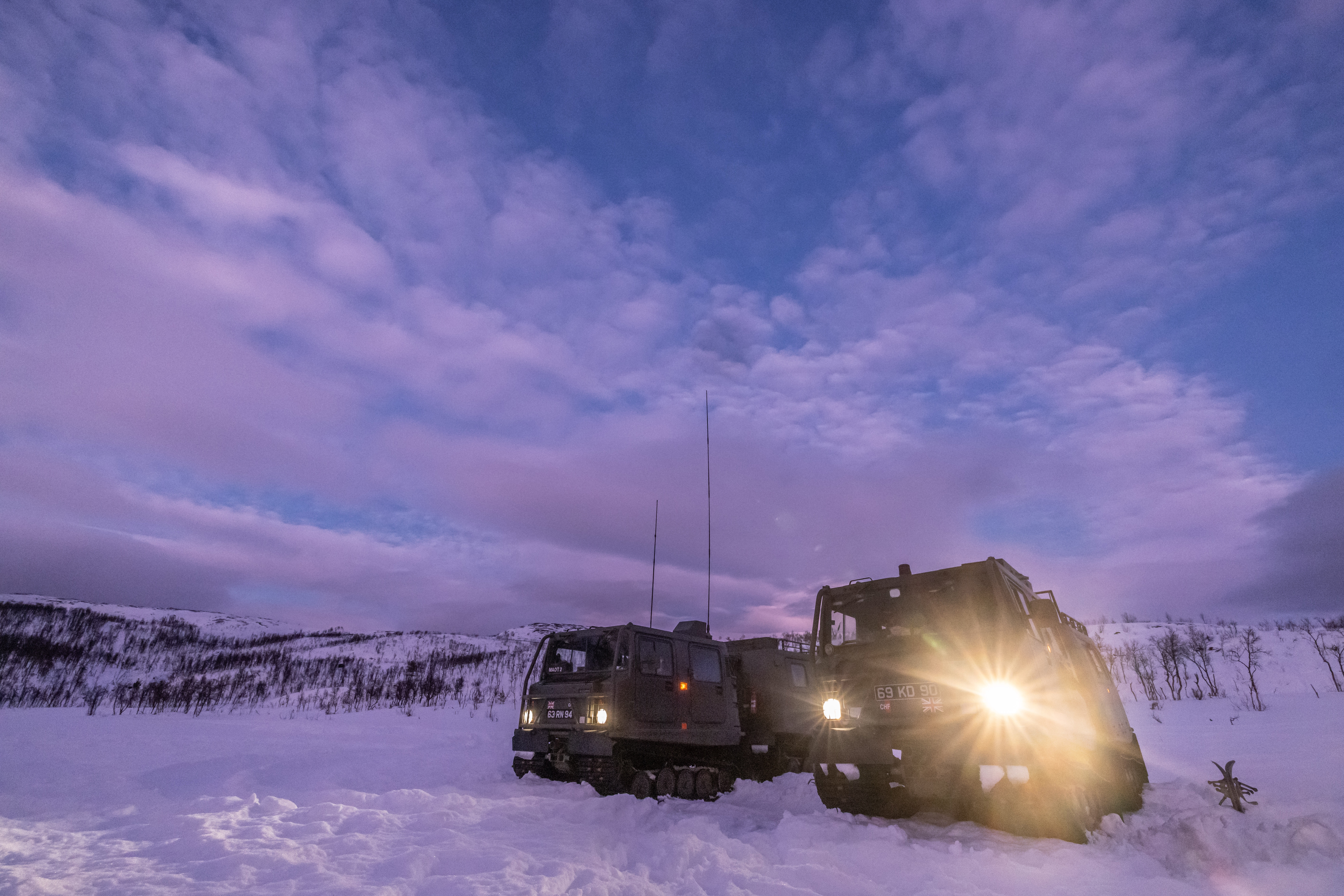 Some of the Commando Helicopter Force's vehicles in front of a purple sky in Norway (Picture: Royal Navy).