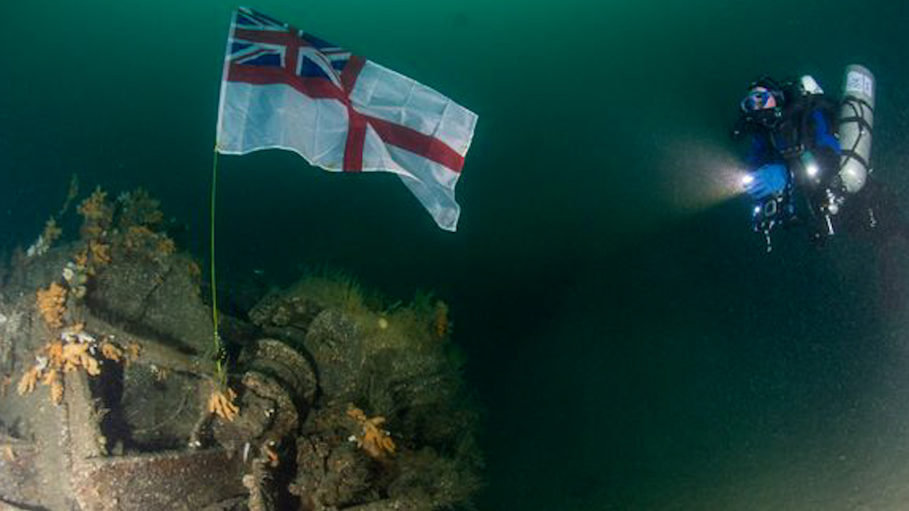 The White Ensign flag was placed back on the lost destroyer HMS Exmouth after she was sunk more than 80 years ago (Picture: Royal Navy)