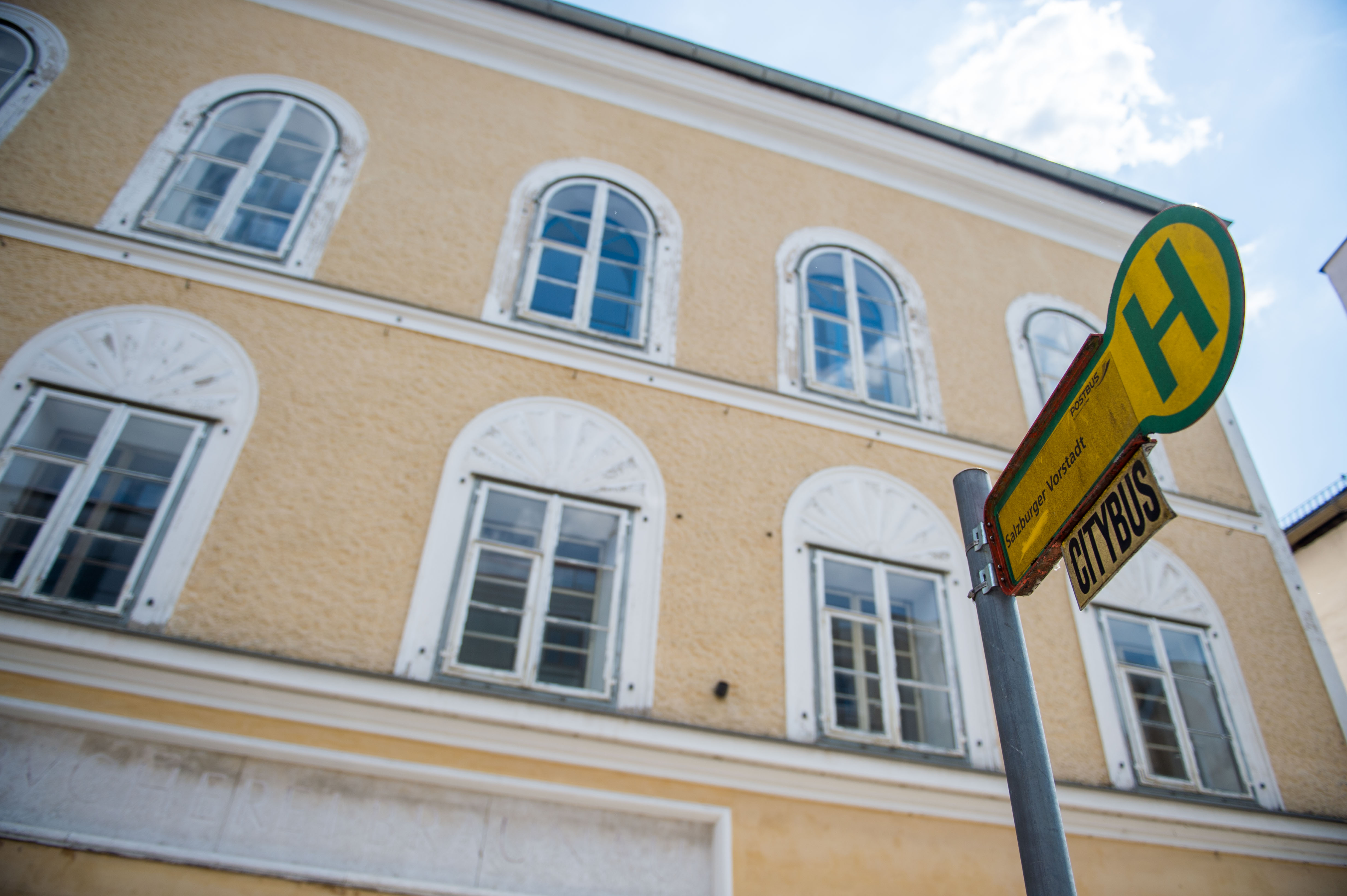 The building where Adolf Hitler's was born in Braunau am Inn in Austria with bus stop in foreground