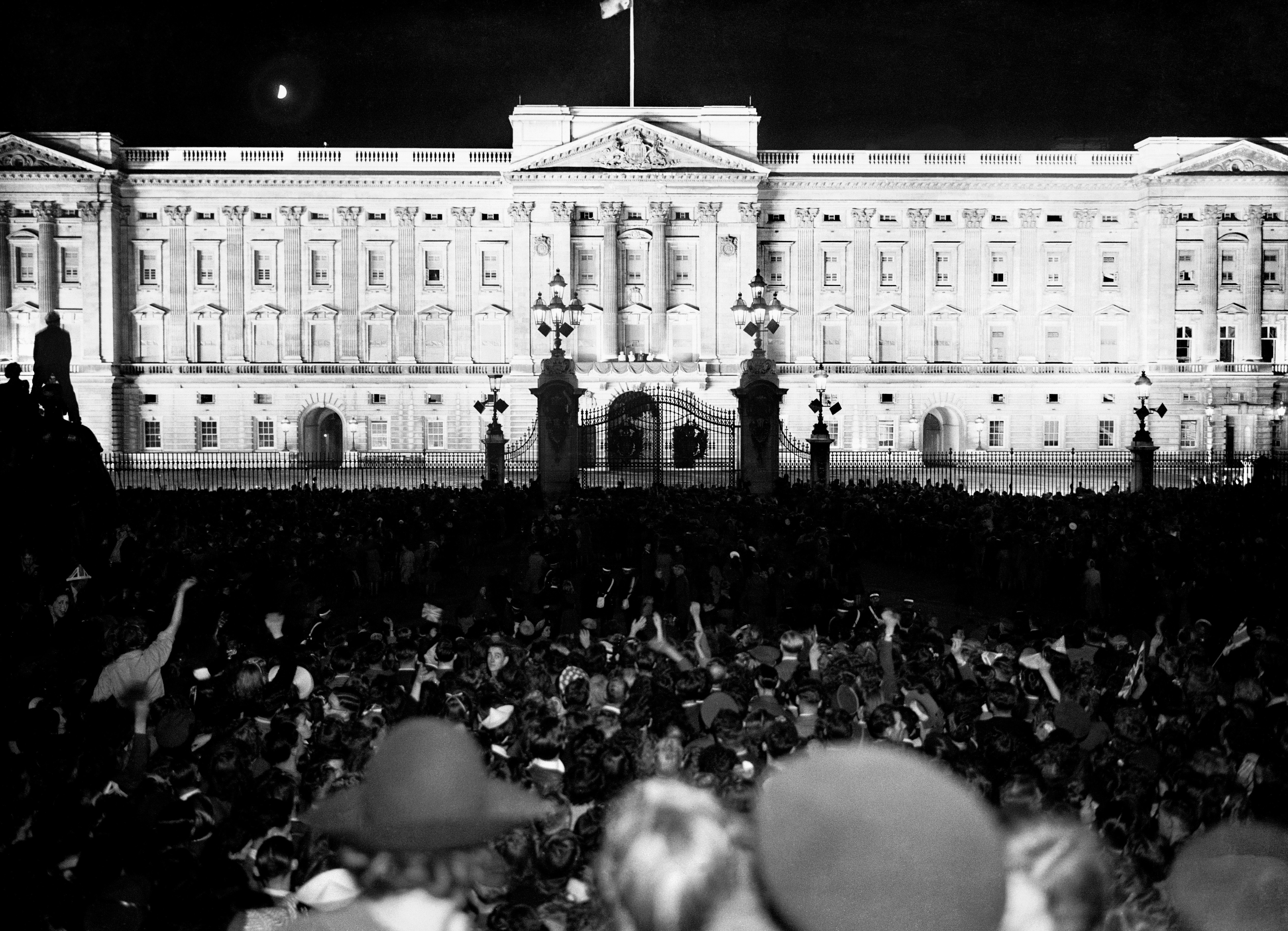 People cheer after listening to King George VI's speech from Buckingham Palace on VJ Day (Picture: EMPICS/PA).