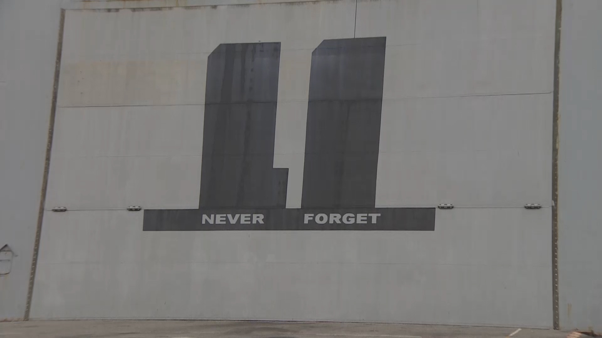 The silhouette of the Twin Towers and "never forget" on the ship.