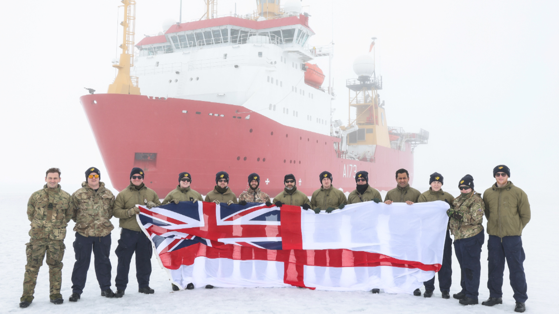 The survey and research team in front of HMS Protector on her record breaking Arctic expedition (Picture: Royal Navy).