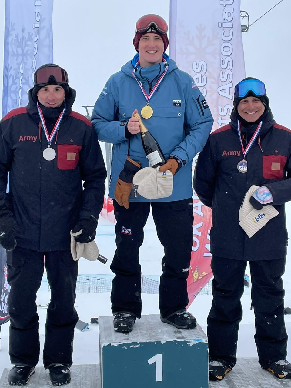 The winner of the ISSSC Snowboard Cross event, Flight Lieutenant Paddy Morris, centre, with second and third places Staff Sergeant Dale Gallagher, left, and Colour Sergeant Sven Benevides, right