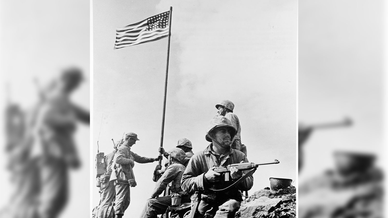 The first flag raising on Mount Suribachi, Iwo Jima, 23 February 1945 ON A BACKGROUND CREDIT Naval History and Heritage Command