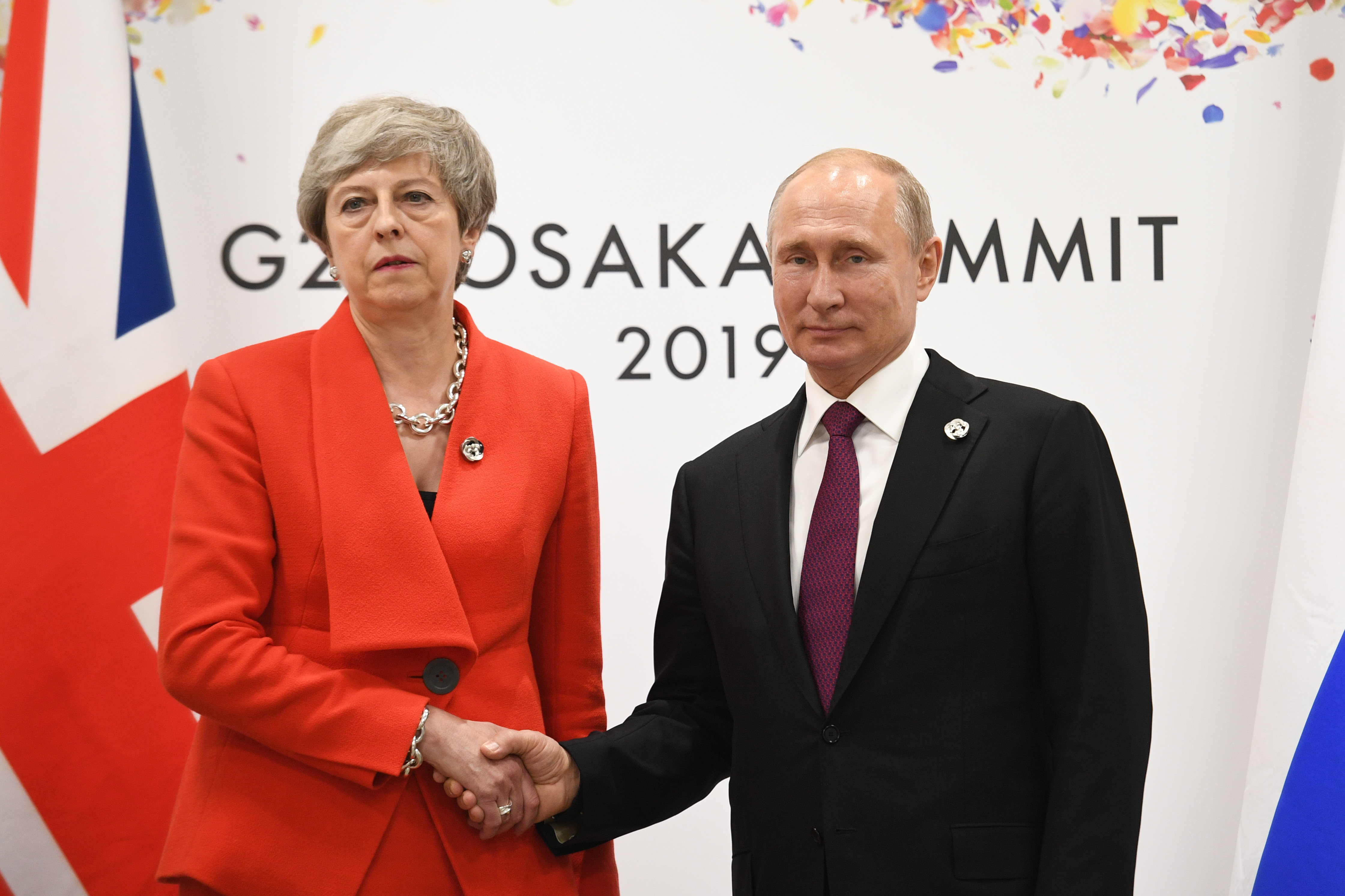 Theresa May and Vladimir Putin shake hands at G20 summit in Japan