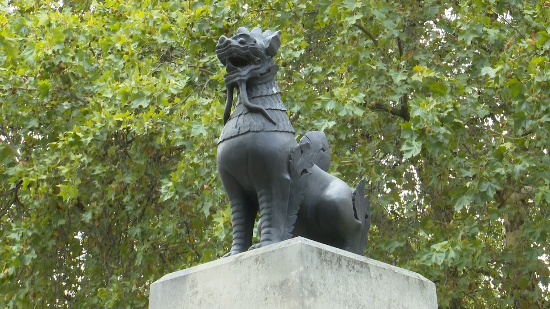 A bronze statue of a mythical beast called a Chinthe sits on top of the memorial's plinth.
