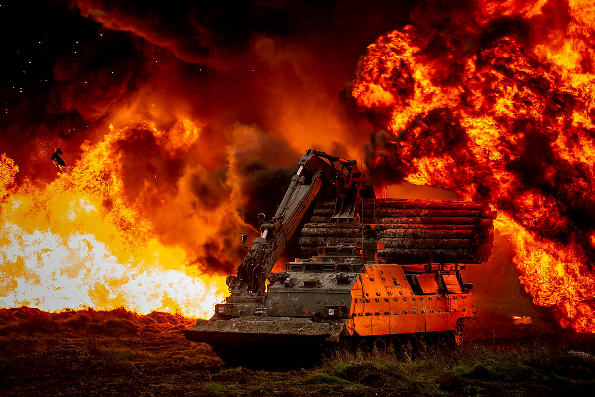 A British Army exercise with simulated explosion and fire taking place on Salisbury Plain and using a Trojan  engineering vehicle