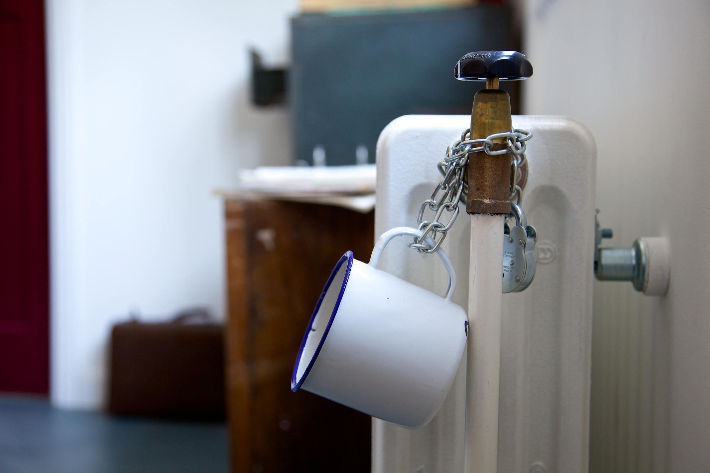 A white tin mug chained to a radiator in Alan Turing's office at Bletchley Park