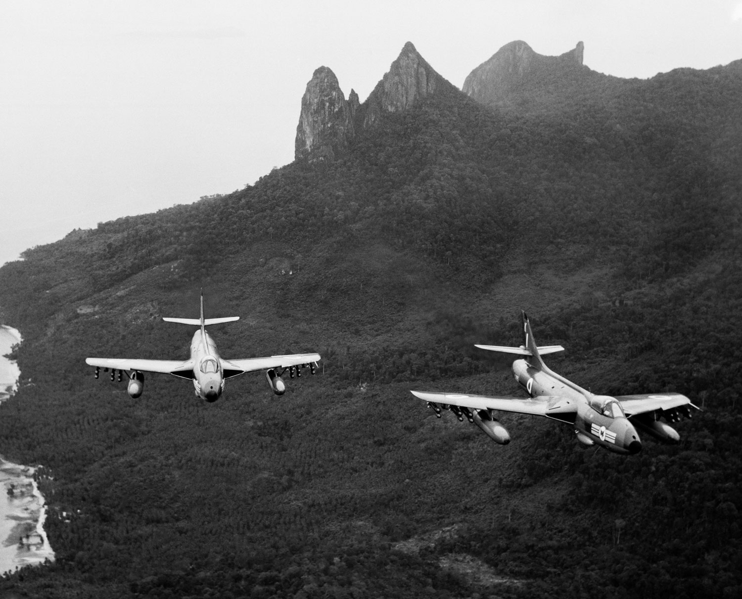 Two Hawker Hunters of 20 Squadron sweeping over Pulau Tioman during an anti-terrorist patrol over Malaya in August 1965 CREDIT Crown Copyright
