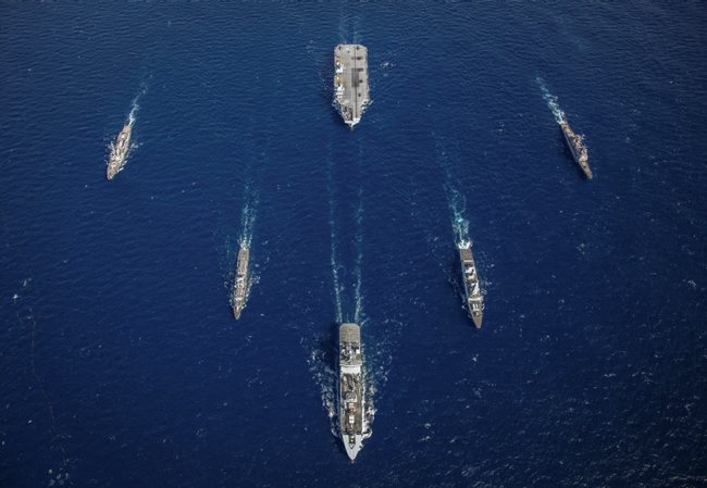 RFA Tideforce (lead), HMS Northumberland (left), USS Truxton (far left), HMS Dragon (right), USS Philippine Sea (far right) with HMS Queen Elizabeth at the rear during Exercise Westlant 19.