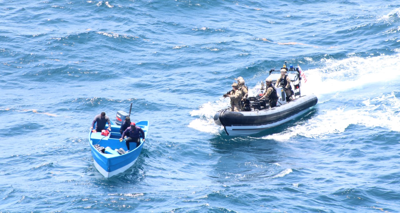 US Coast Guards, deployed from RFA Wave Knight, seizing a suspected drug trafficking vessel in international waters near South America