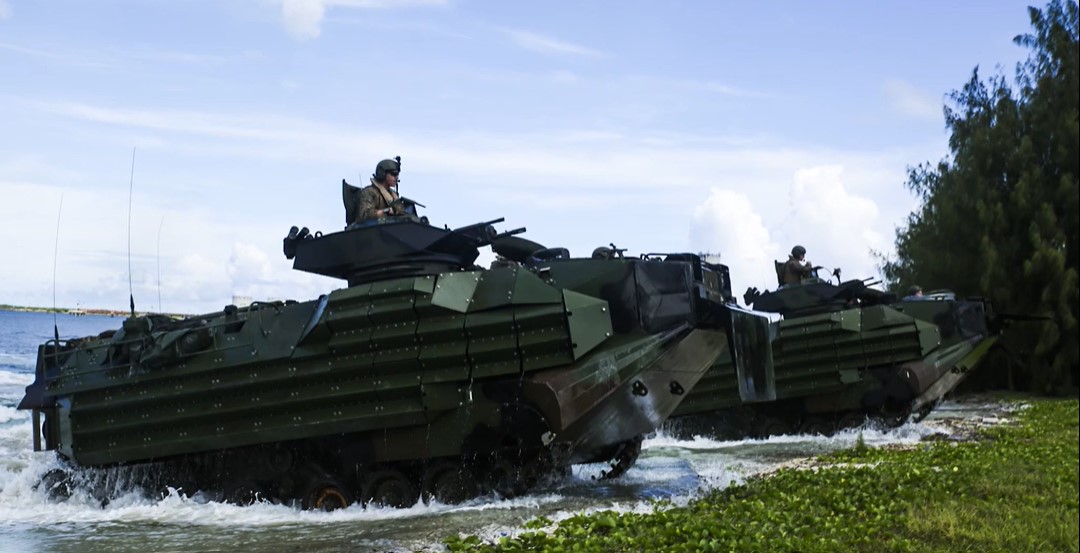 Amphibious Assault Vehicle 7s shown driving up a beach - these vehicles support US Marines