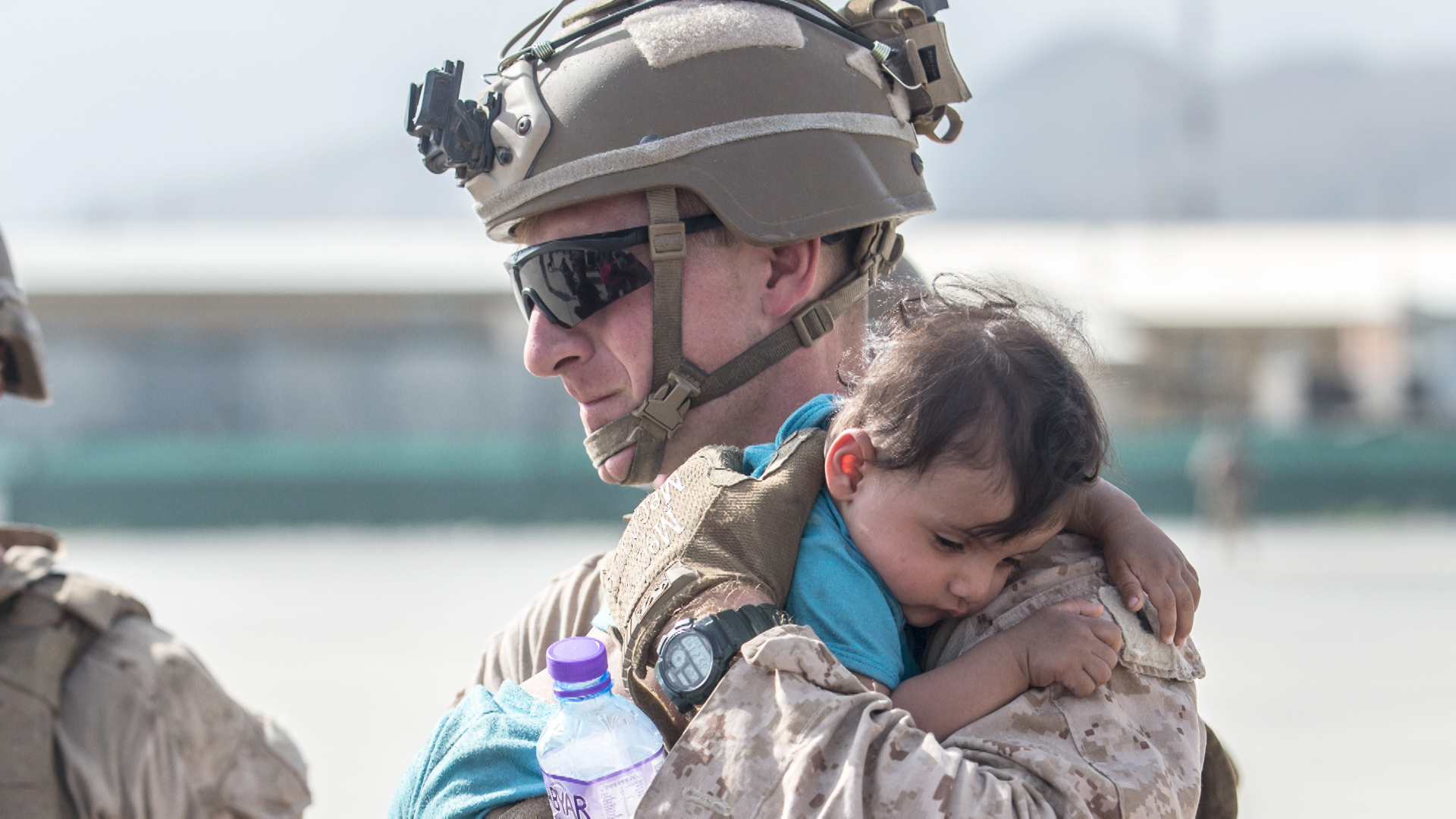 US Marine calms an infant 