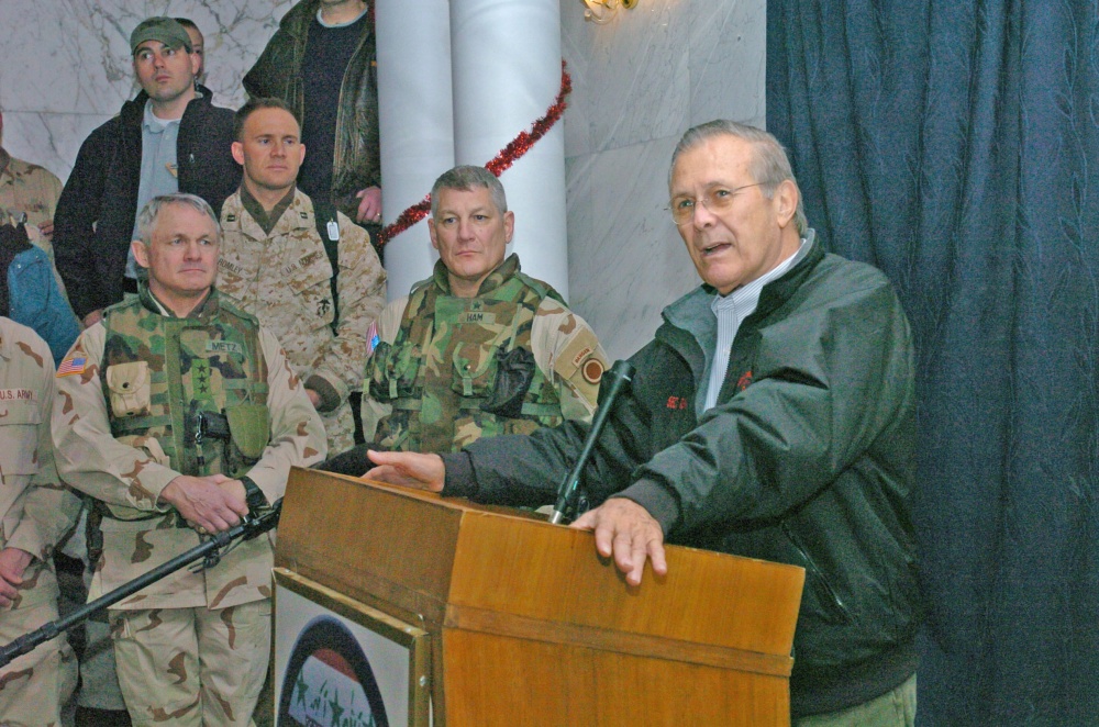 Donald Rumsfeld speaks to soldiers in Iraq in 2004