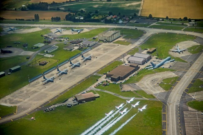 US Thunderbirds fly behind a KC-135 Stratotanker over RAF Mildenhall