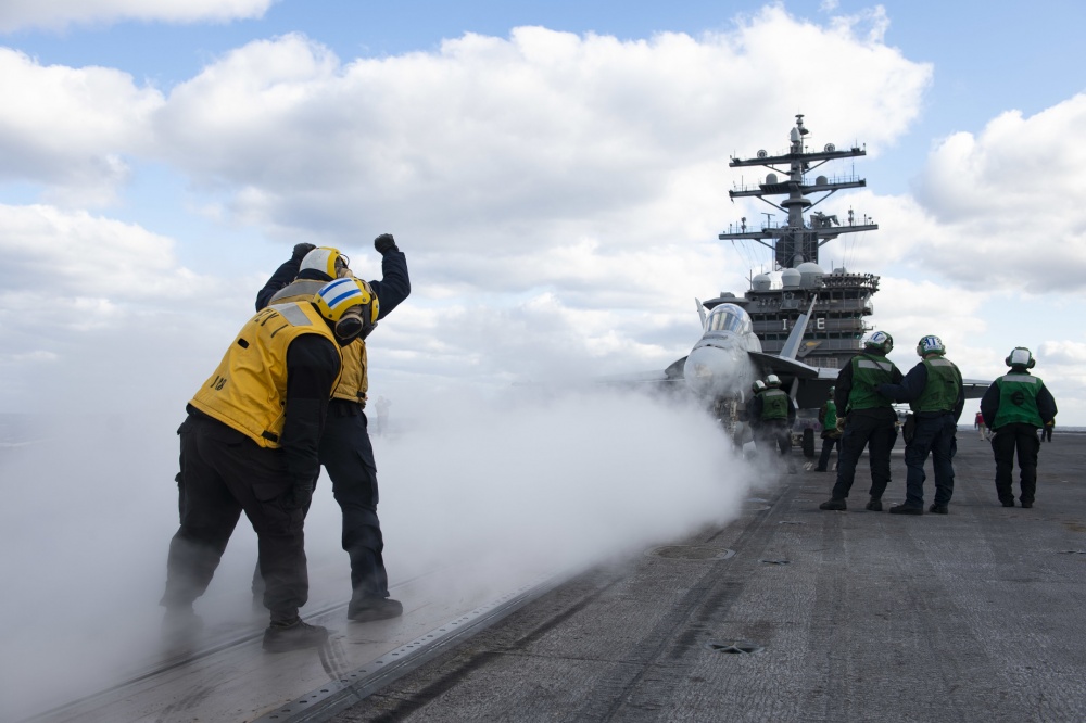 US personnel prepare to launch FA-18 Super Hornet from deck of USS Dwight D Eisenhower