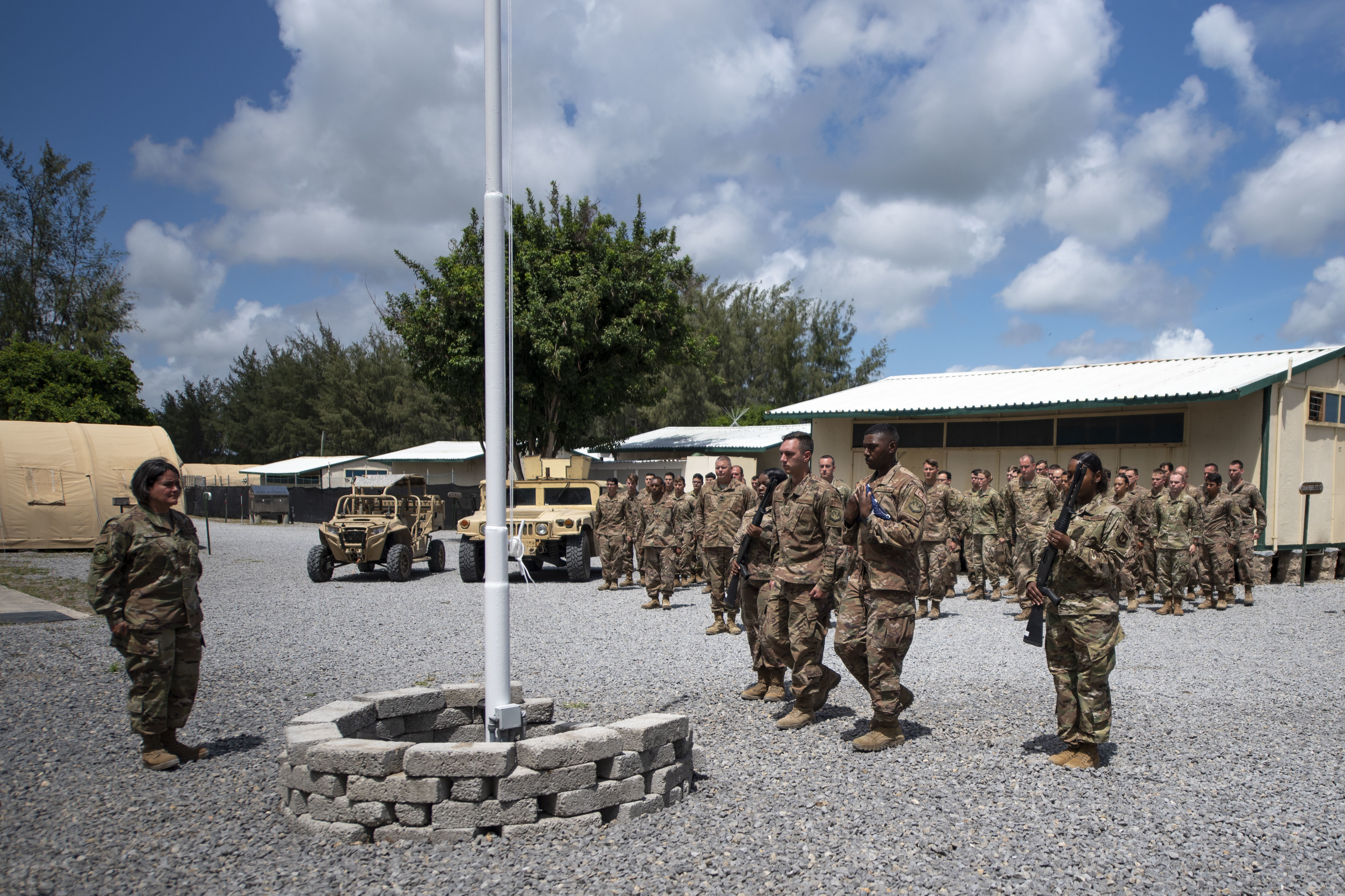 Cover Image: US troops during a flag-raising ceremony at Manda Bay Airfield (Picture: US Department of Defense).
