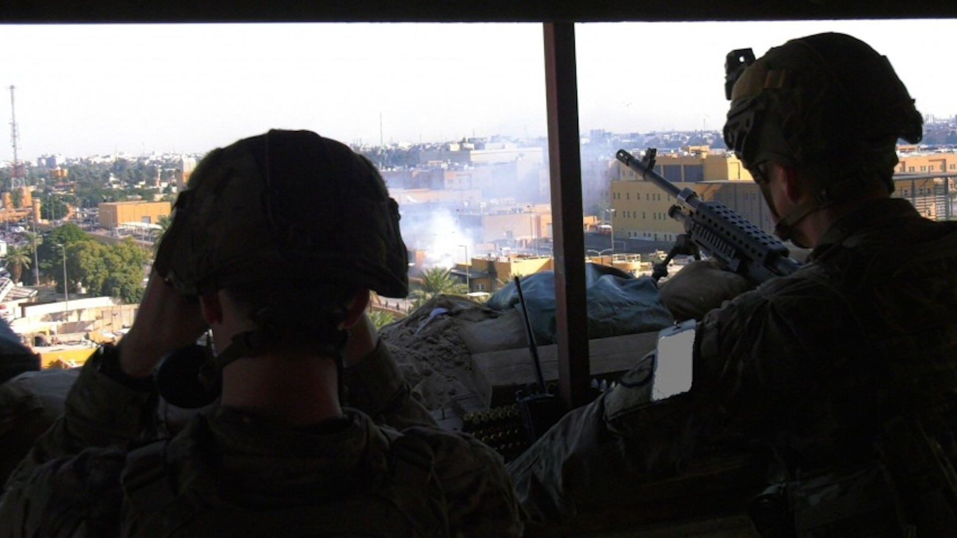 US troops watch the crowd protesting outside a section of the U.S. Embassy in Iraq in Baghdad, on January 1st, 2019 (Picture: US Department of Defense).