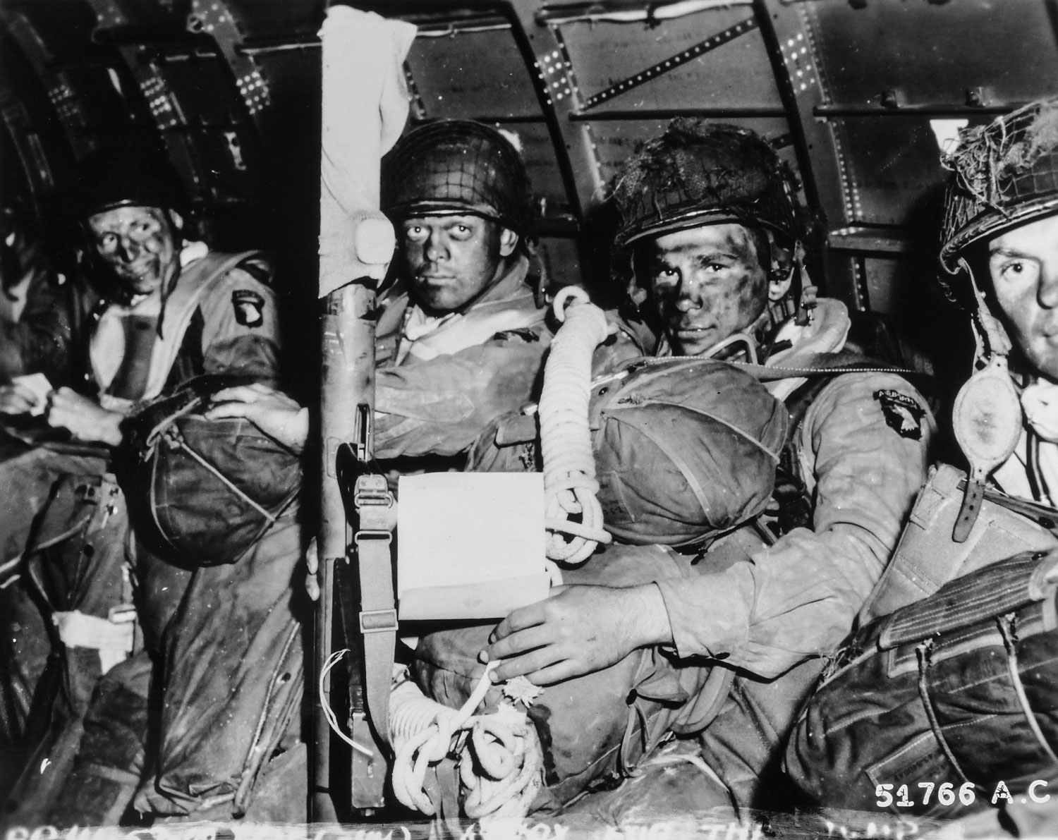 Resolute faces of U.S. Army paratroopers just before they took off for the initial assault of D-Day Credit DVIDS and Katie Lange