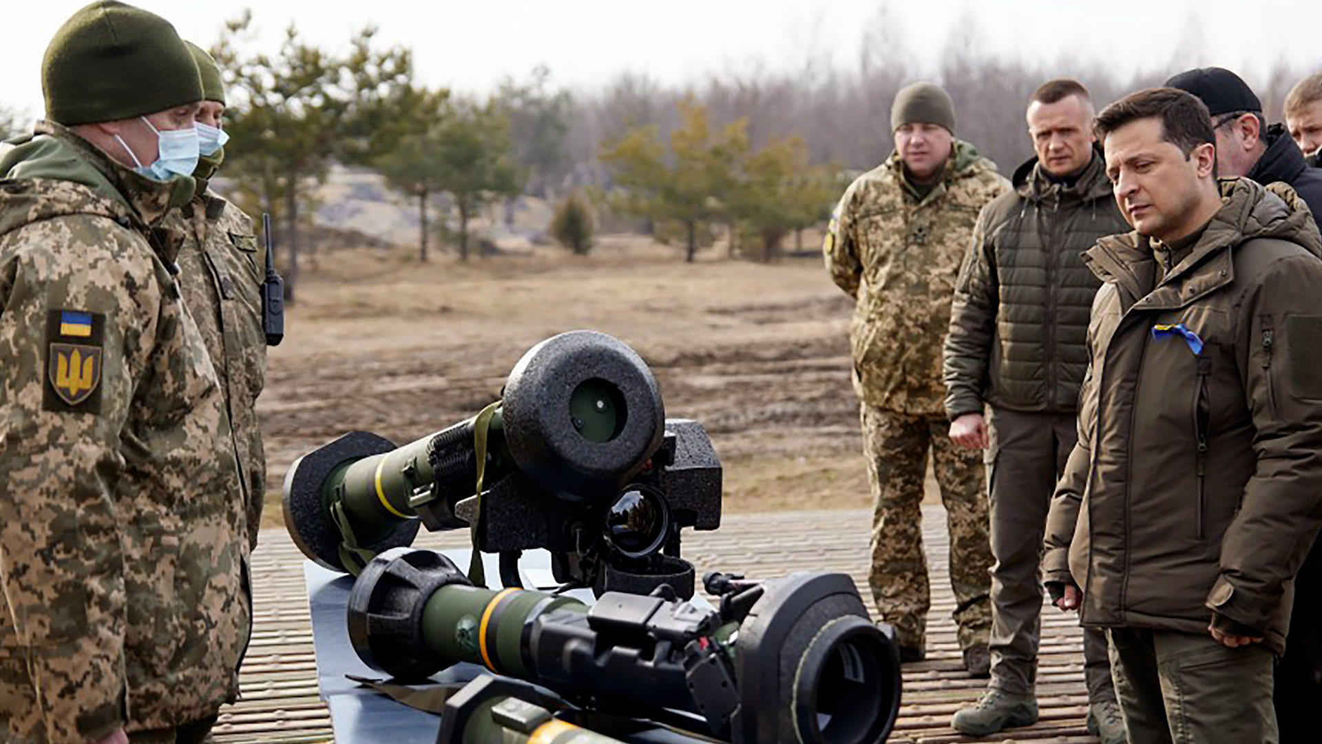Ukrainian President Volodymyr Zelensky (R) listens to explanations during a military drill outside the city of Rivne, northern Ukraine 