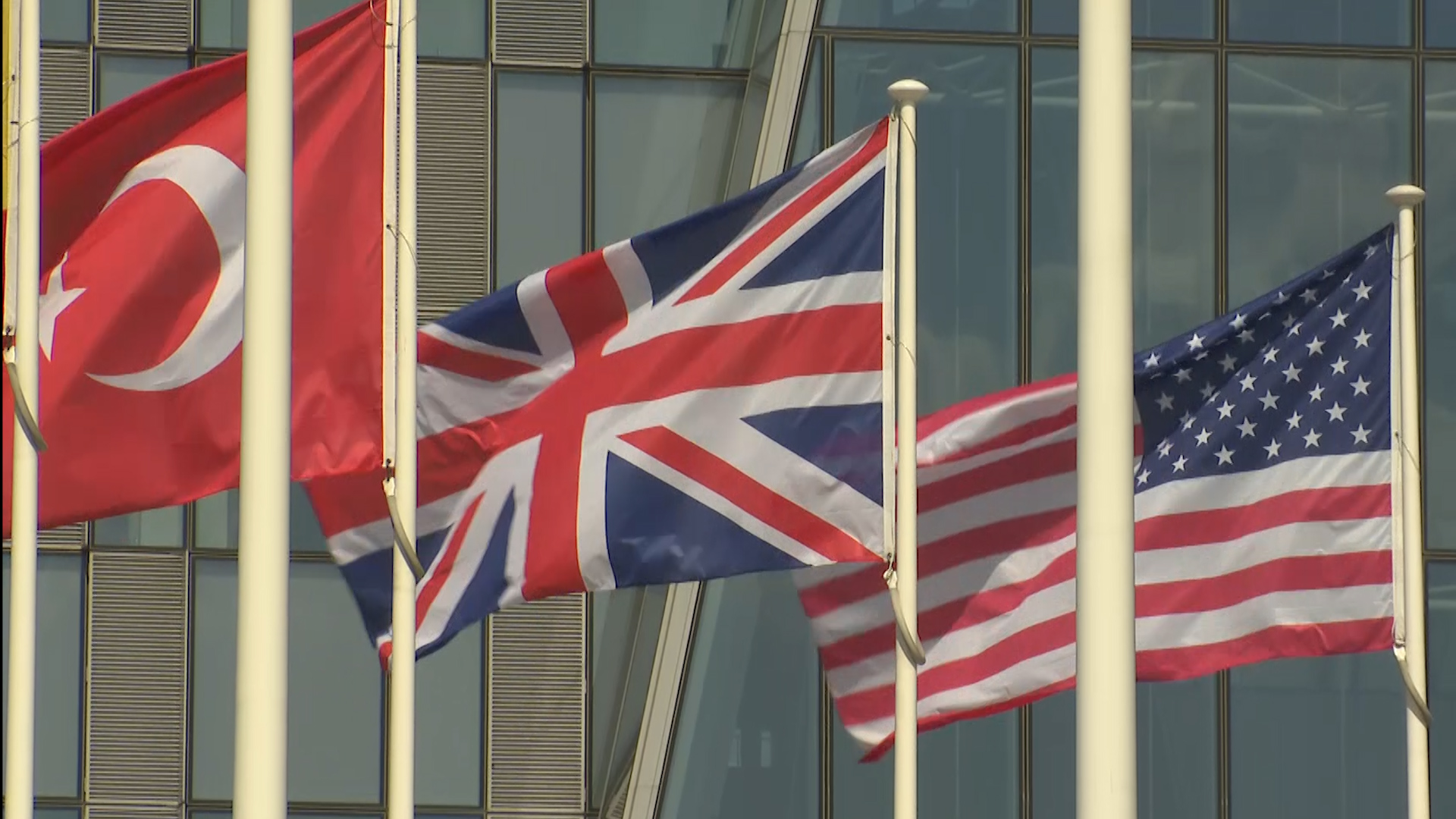 Union Jack in centre with Turkish flag to the left and US flag to its right