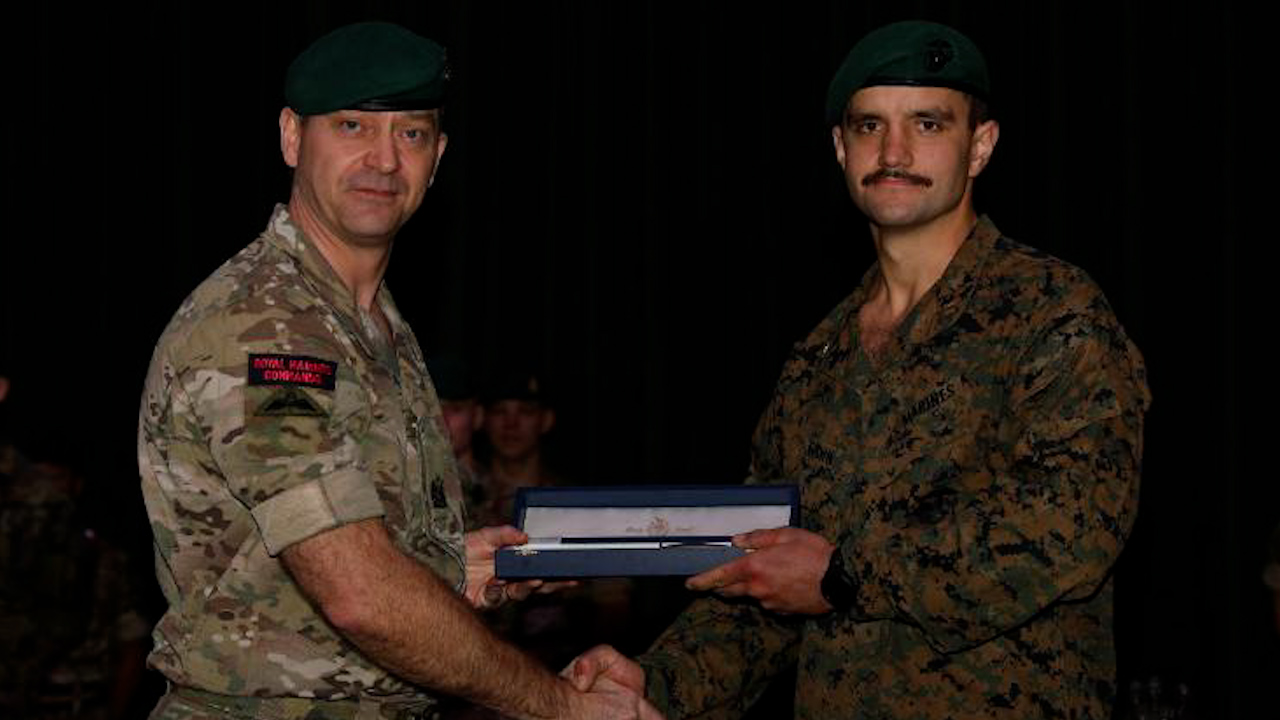 US Marines Corps Captain Brown receiving his green beret from the Commando All-Arms Course (Picture: Royal Marines Commando Training Centre X).