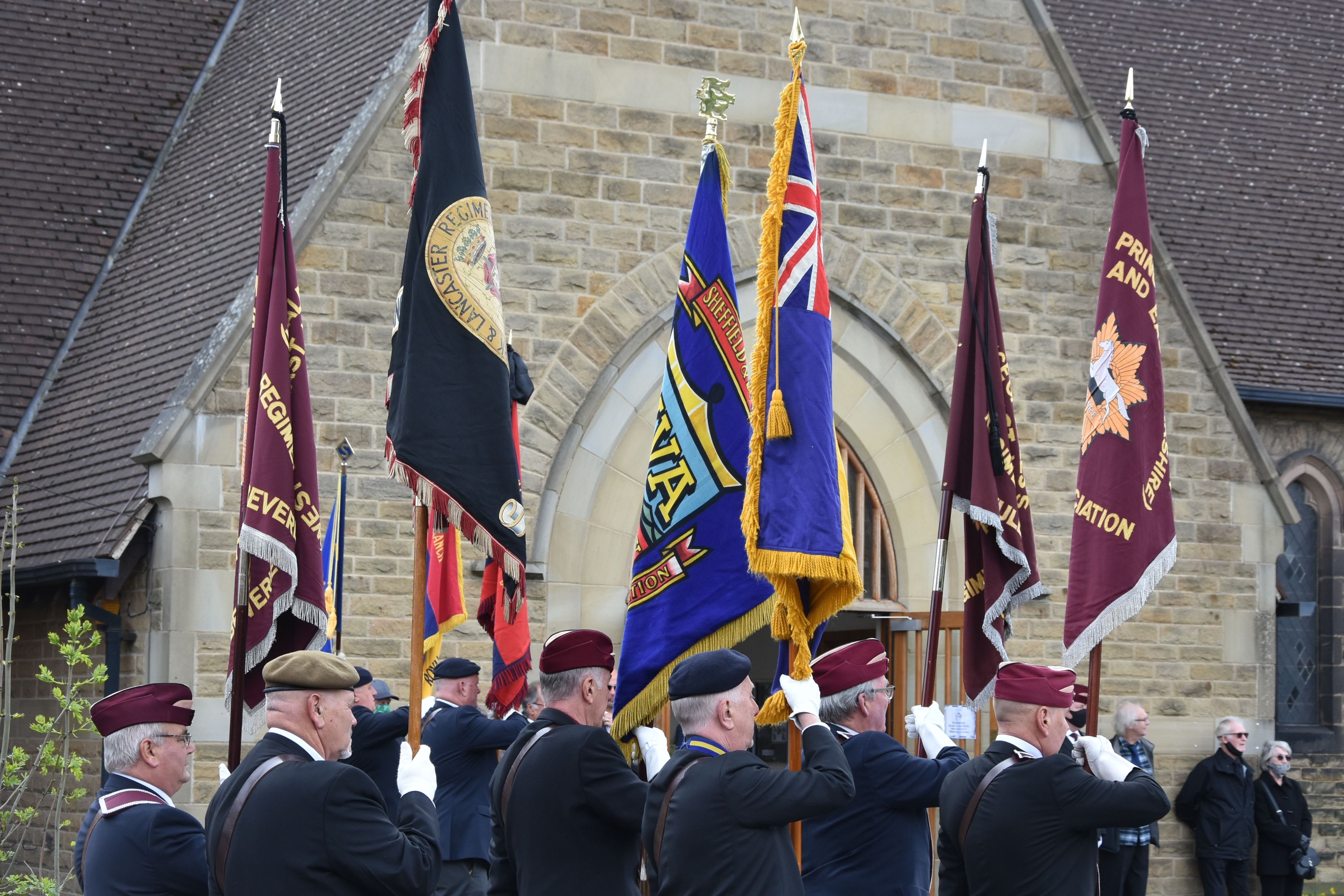 Veterans holding flags at the funeral of Douglas Parker, a D-Day veteran who died aged 98 