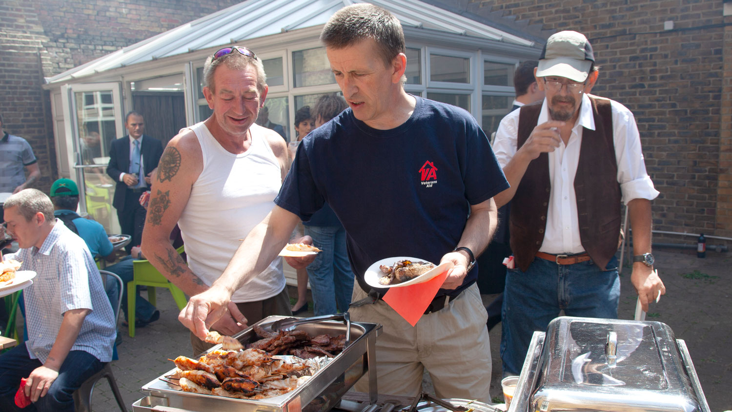 Former service personnel enjoy a BBQ at New Belvedere House thanks to Veterans Aid (Picture: VA / Glyn Strong).