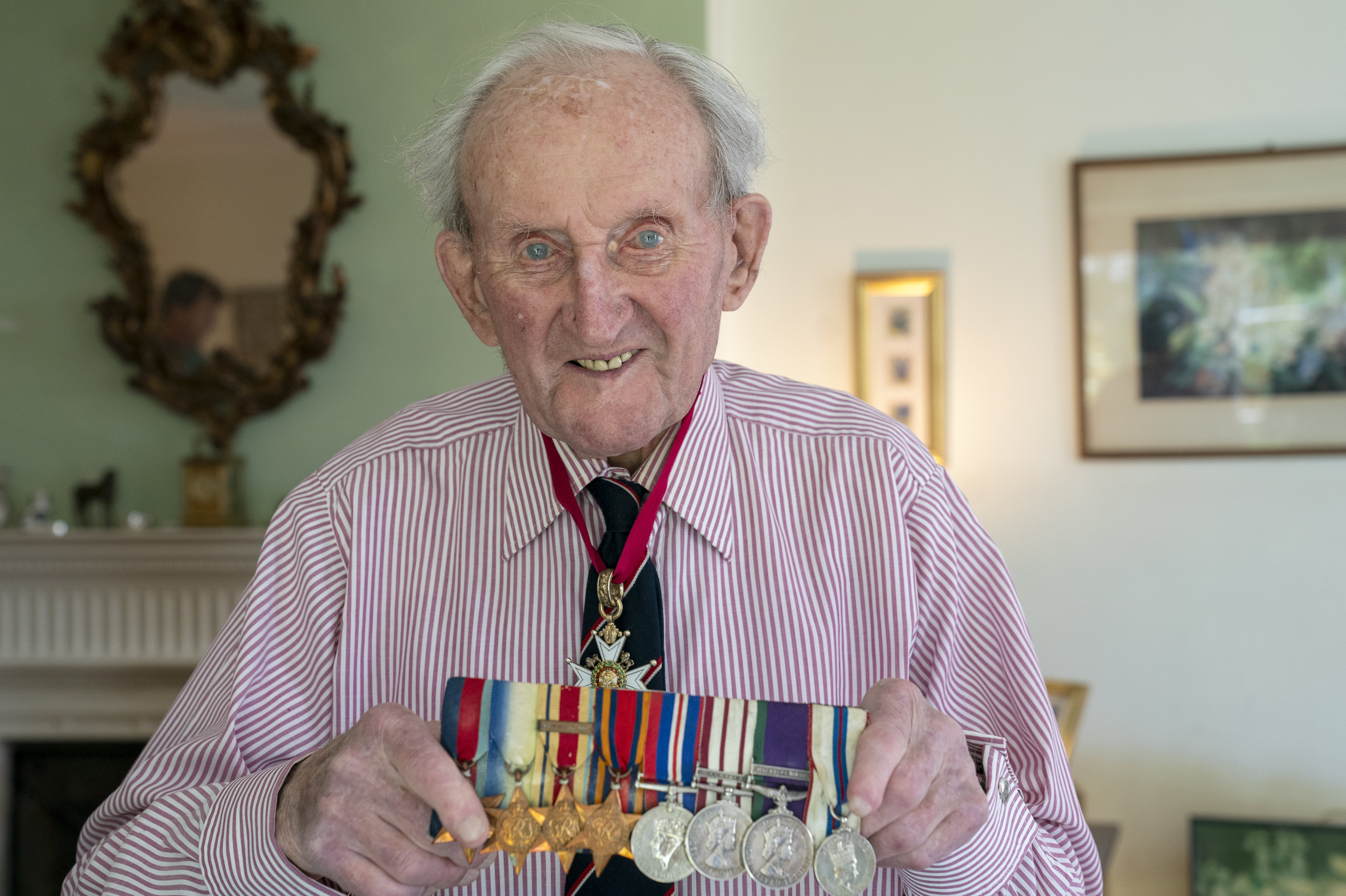 Vice Admiral Sir Thomas Baird, from Symington in Ayrshire, holding up his medals as he celebrates his 100th birthday 180524 CREDIT PA