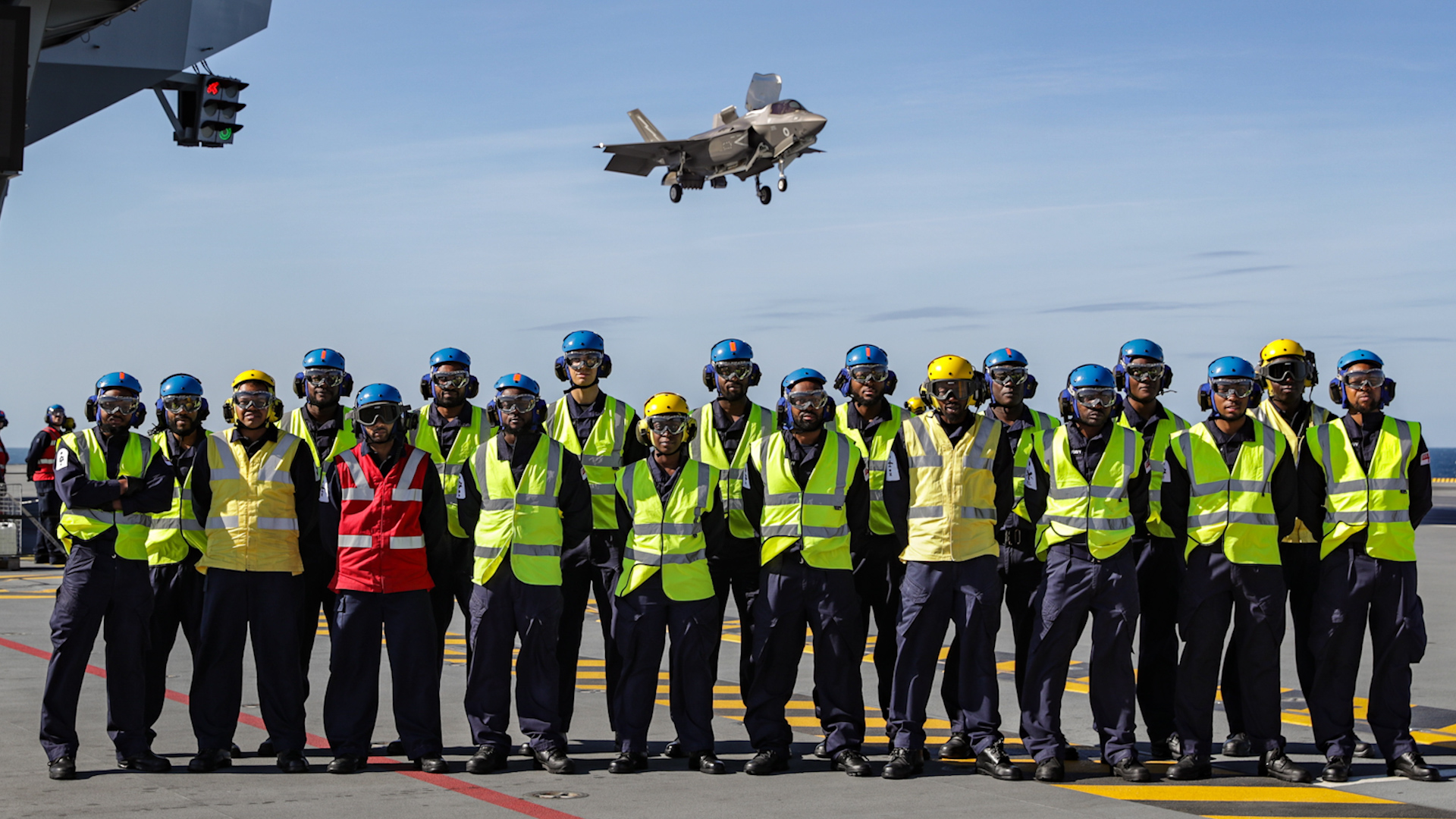 Vincentian members of HMS Queen Elizabeth crew pose with an F-35 to mark Independence Day in 2019 CREDIT ROYAL NAVY