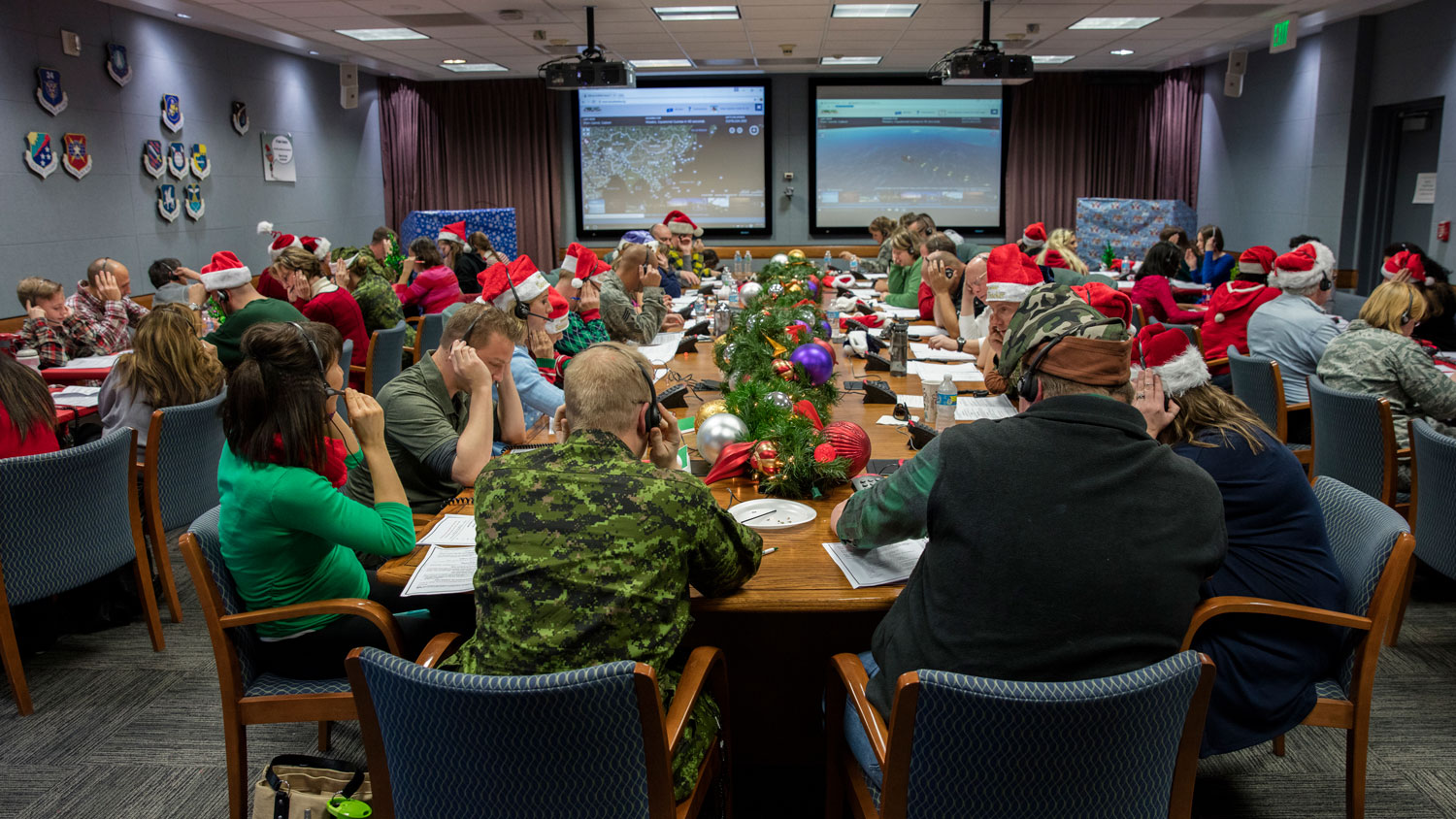 Volunteers answer phones during the annual NORAD Tracks Santa event at Peterson AFB in December 2016 CREDIT NORAD