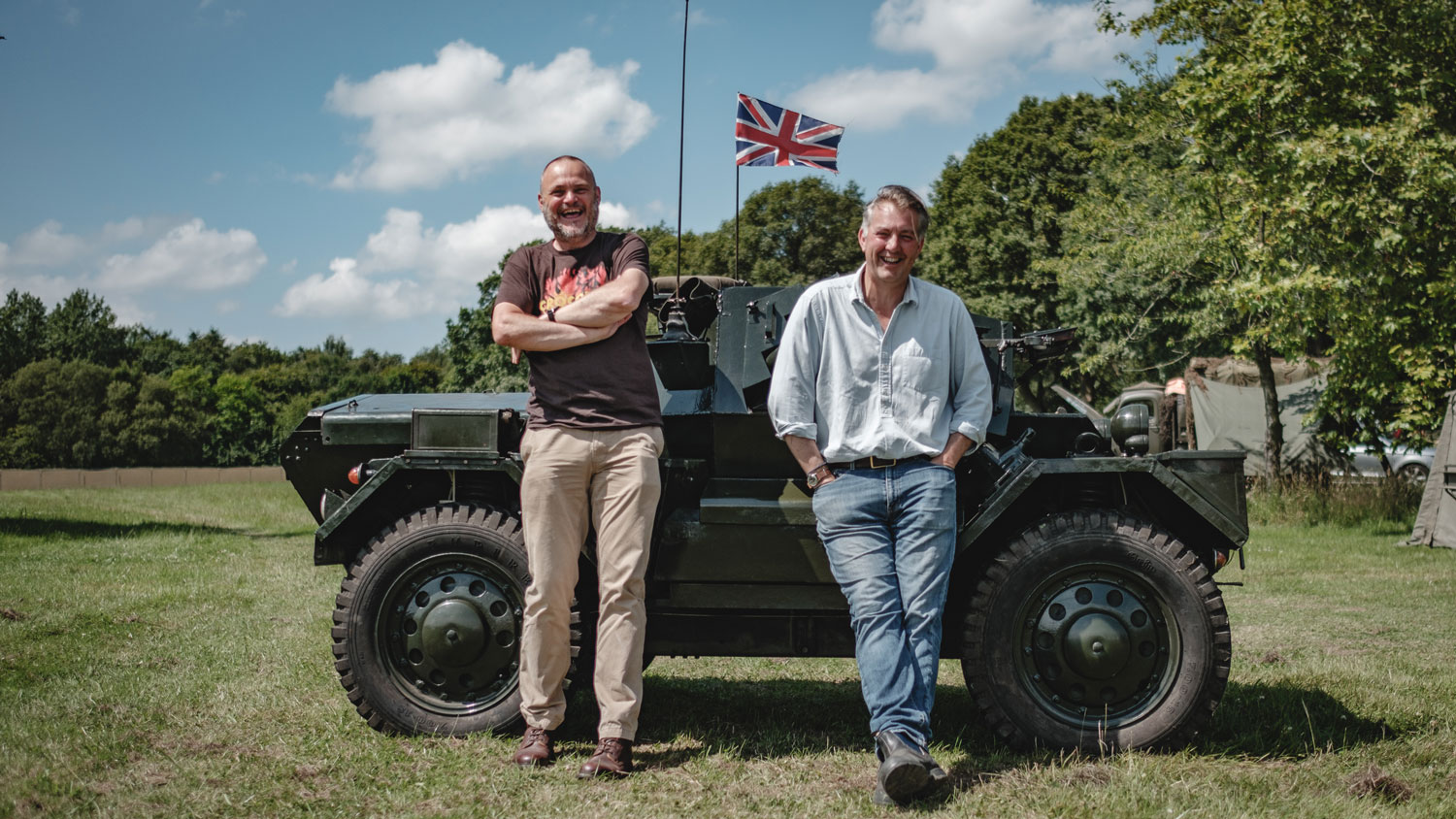 We Have Ways Of Making You Talk podcast hosts Al Murray and James Holland stand infront of a Daimler Dingo CREDIT Goalhanger