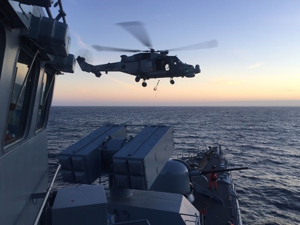 Royal Navy warship and Wildcat helicopter