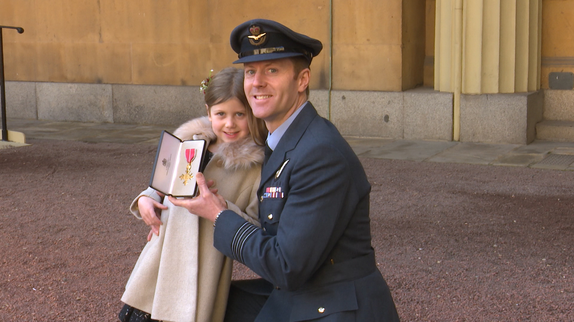 Wing Commander Gatland and his daughter at the investiture ceremony 210219 CREDIT BFBS
