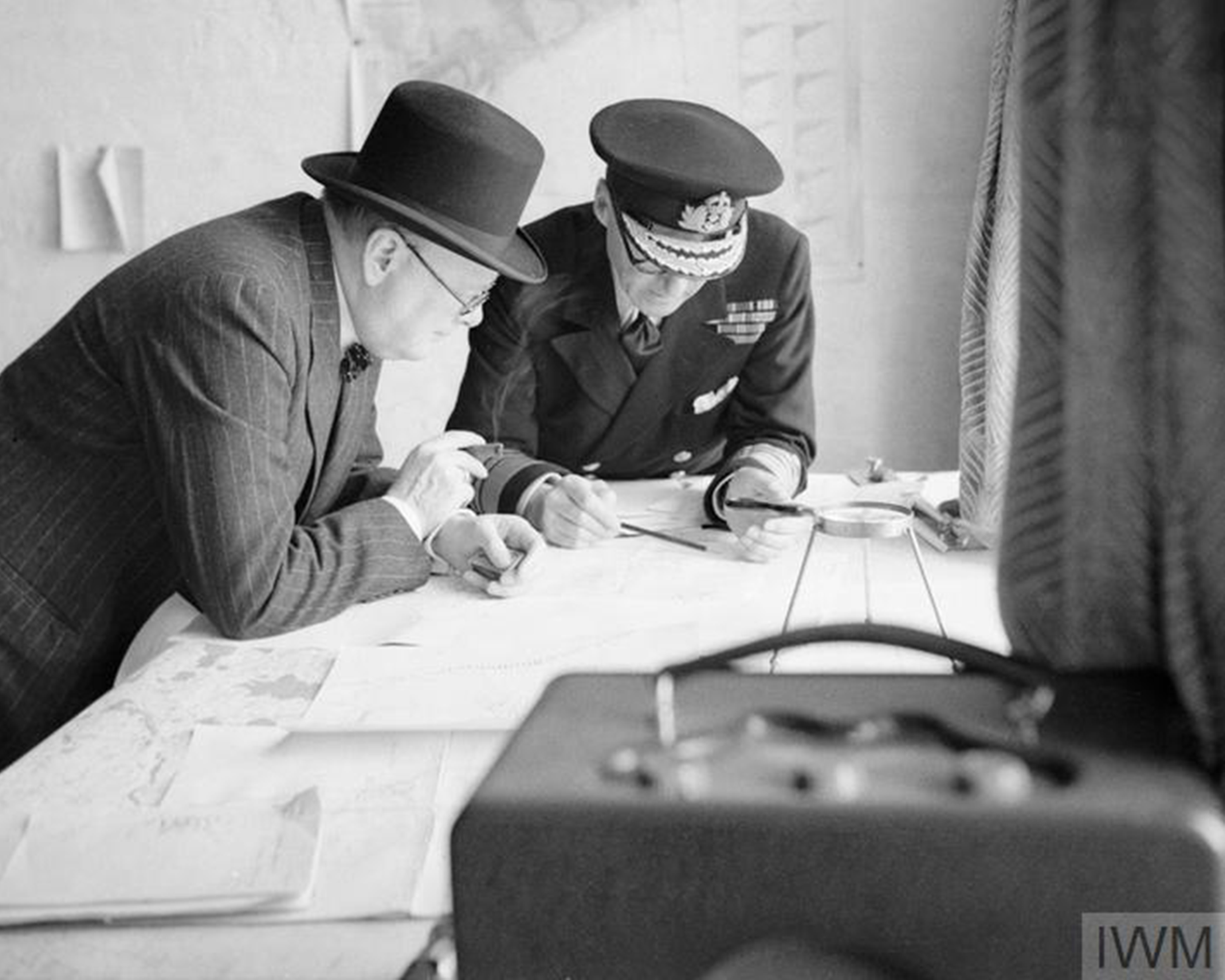 Prime Minister Winston Churchill studies reports of the action that day with Vice Admiral Sir Bertram Ramsay, Flag Officer Commanding Dover © IWM (H 3508)