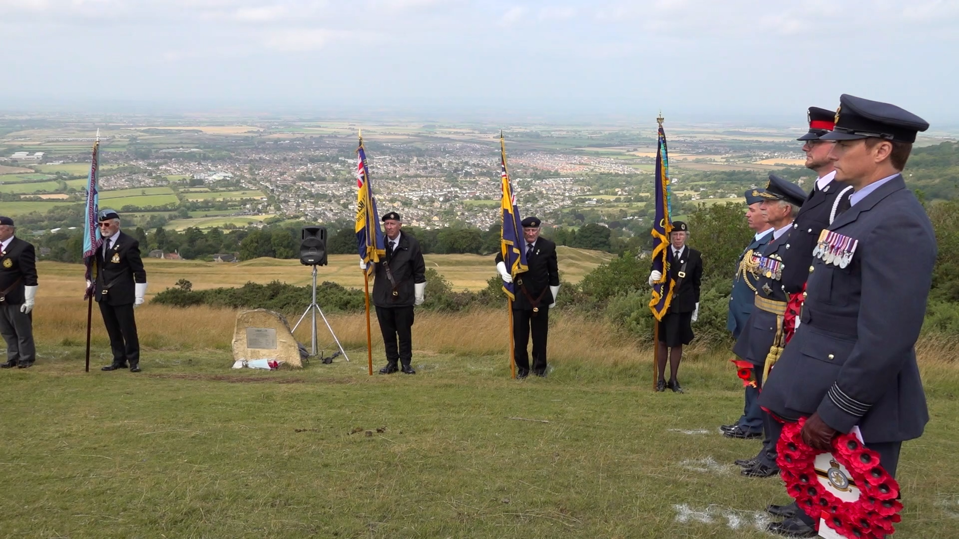 Wreaths were laid on Cleeve Hill as part of the service to remember the victims of a Second World War airplane crash that killed seven airmen 260824 CREDIT Julian Wellings