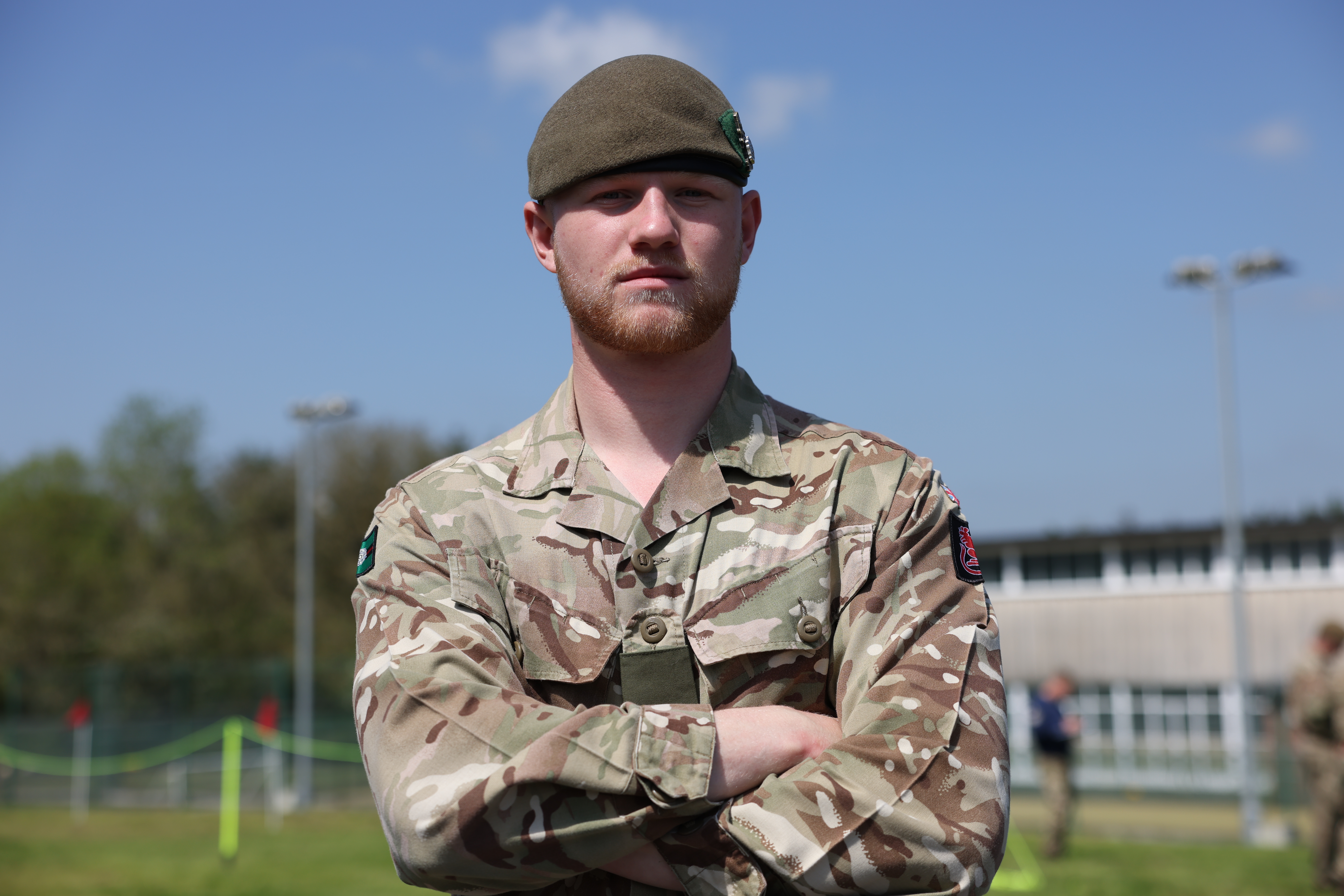 Soldier stands with arms folded