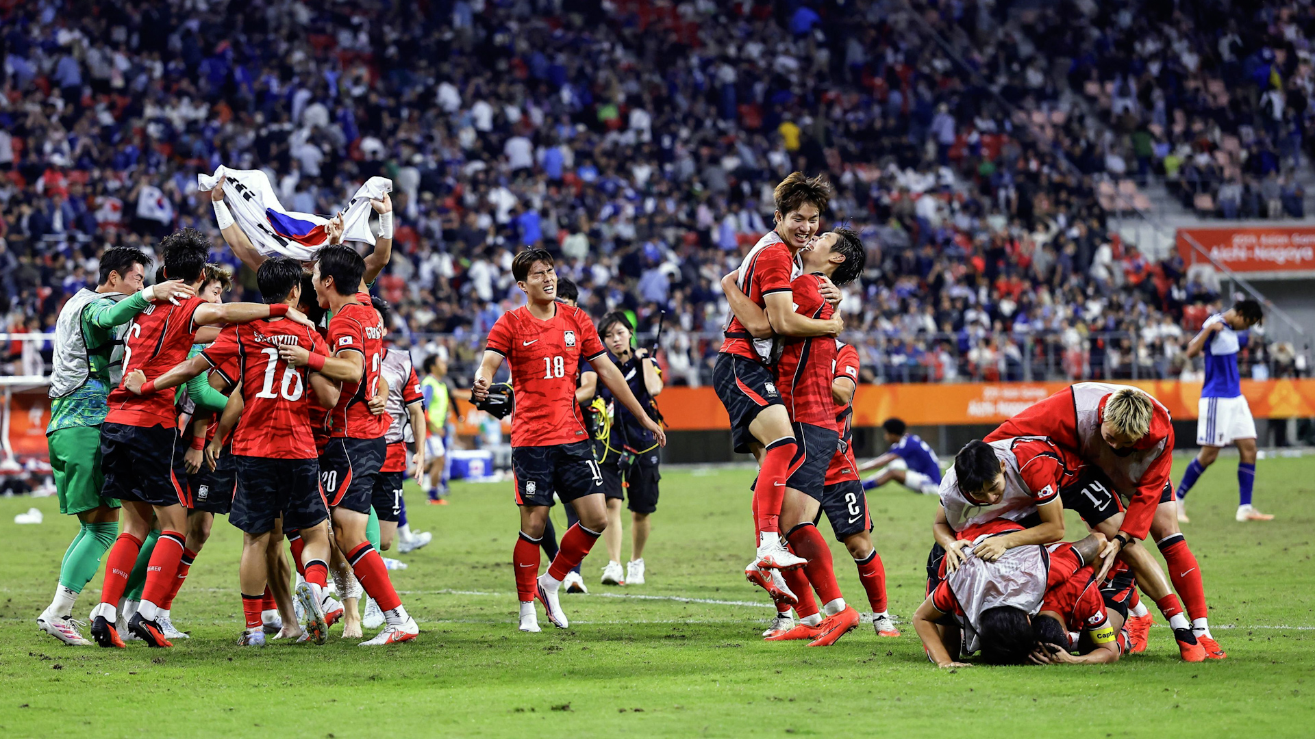South Korea players celebrate after beating Japan in the Aichi-Nagoya As