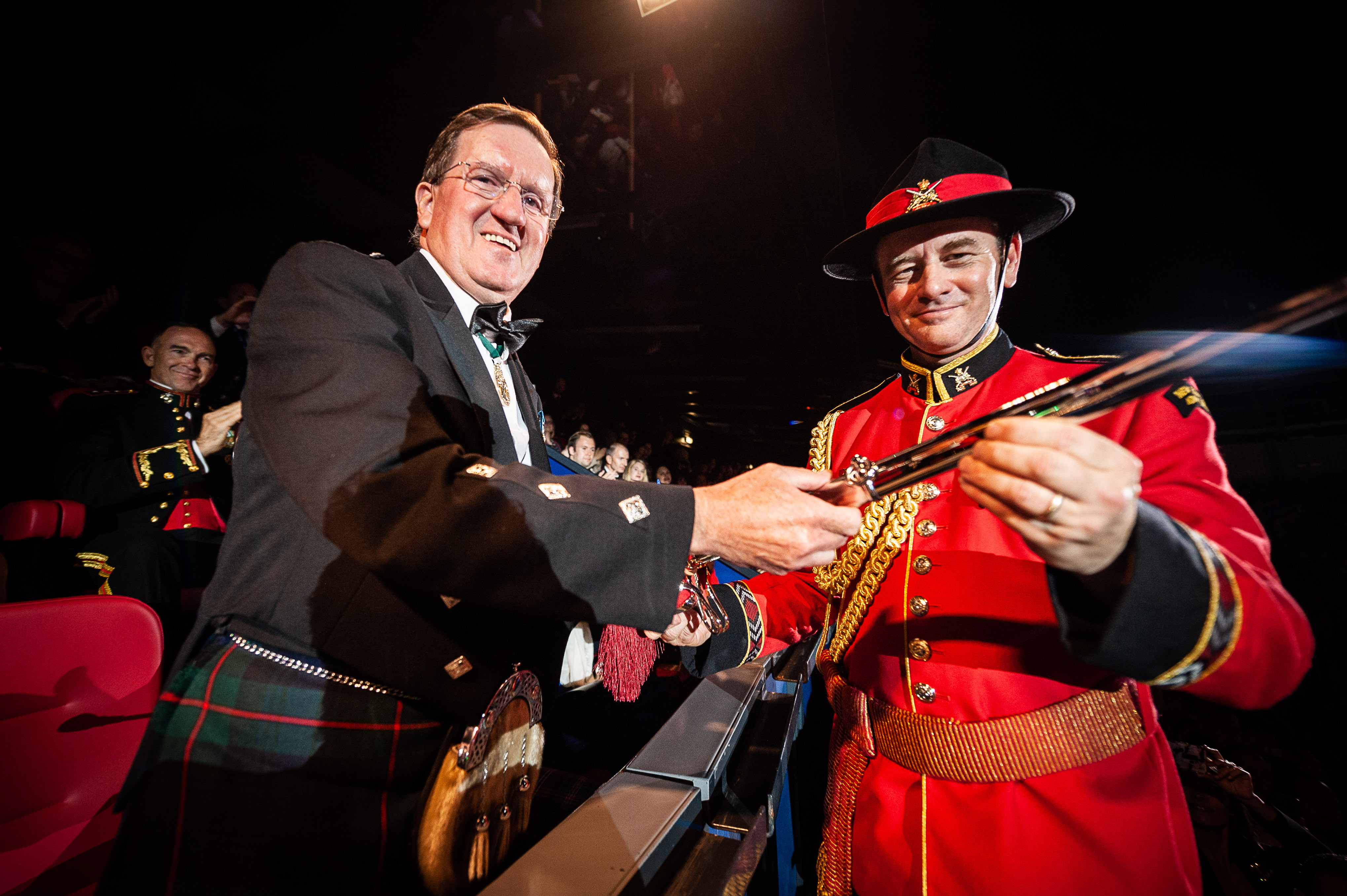 Salute Taker Lord George Robertson presented Major Graham Hickman of the New Zealand Army Band with the Pooley Sword Award.