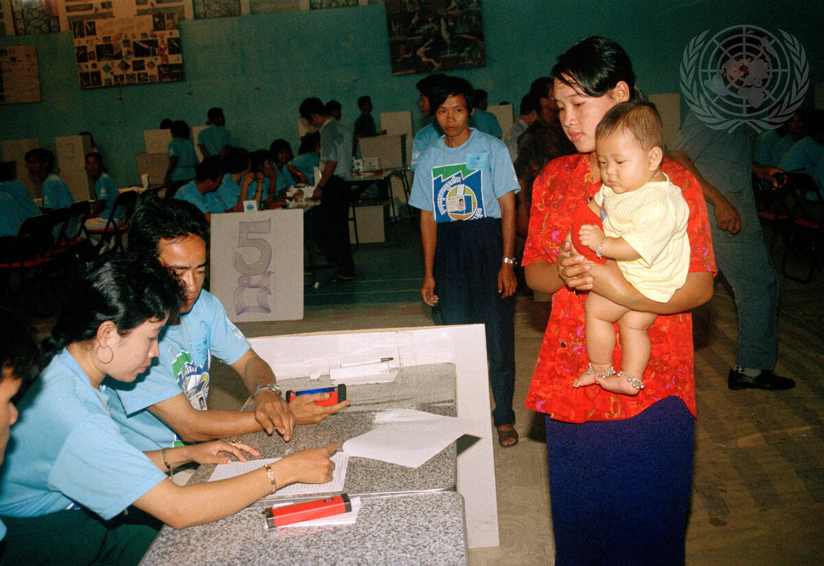 A Cambodian voter and her child at a polling station in Phnom Penh on the first day of voting.  The election, for a national constituent assembly, is being carried out under the supervision of UNTAC. Credit: UN Photo/John Isaac