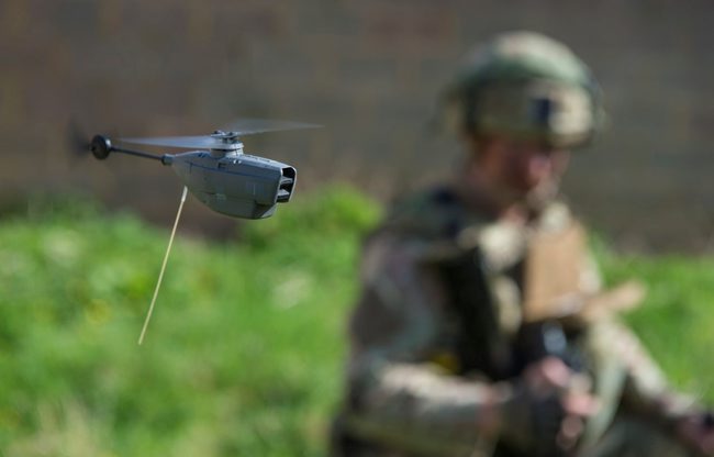 The British micro-drone, Black Hornet, controlled by a Royal Marine (Picture: MOD).