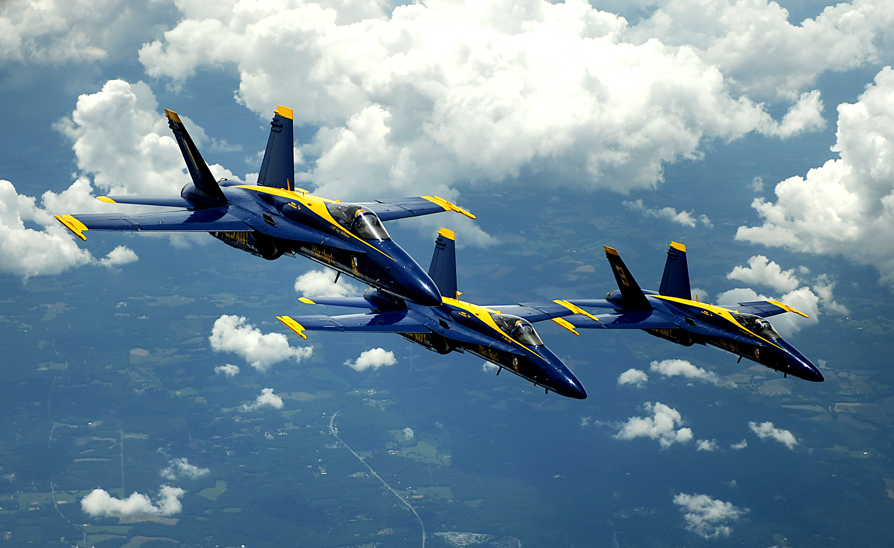 F/A-18 Hornet strike fighters assigned to the U.S. Navy flight demonstration squadron the Blue Angels pull into formation after being refueled from a KC-135 Stratotanker with the 756th Air Refueling Squadron
