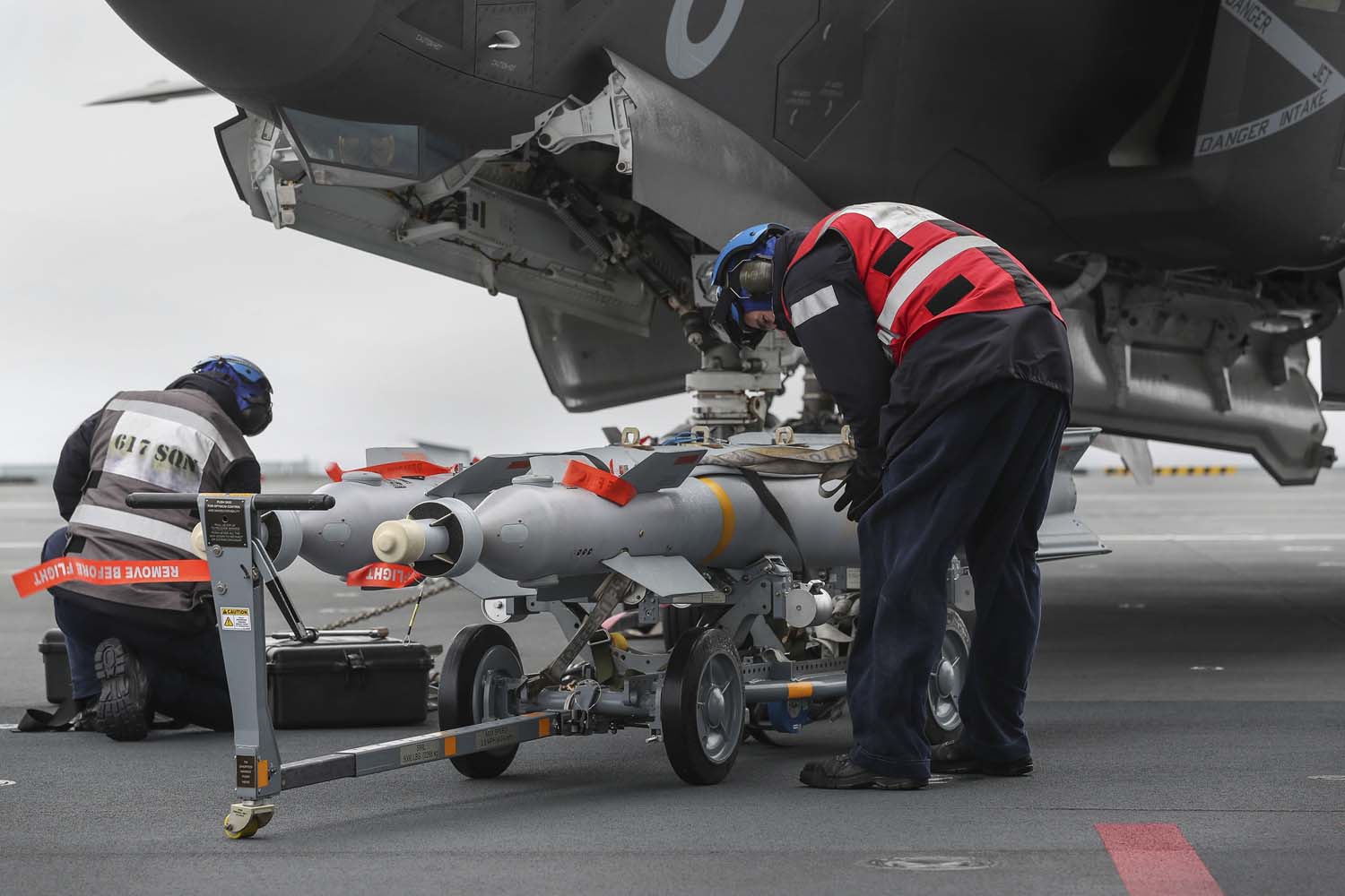 An F-35 jet is loaded with live weapons on board HMS Queen Elizabeth (Picture: Royal Navy).